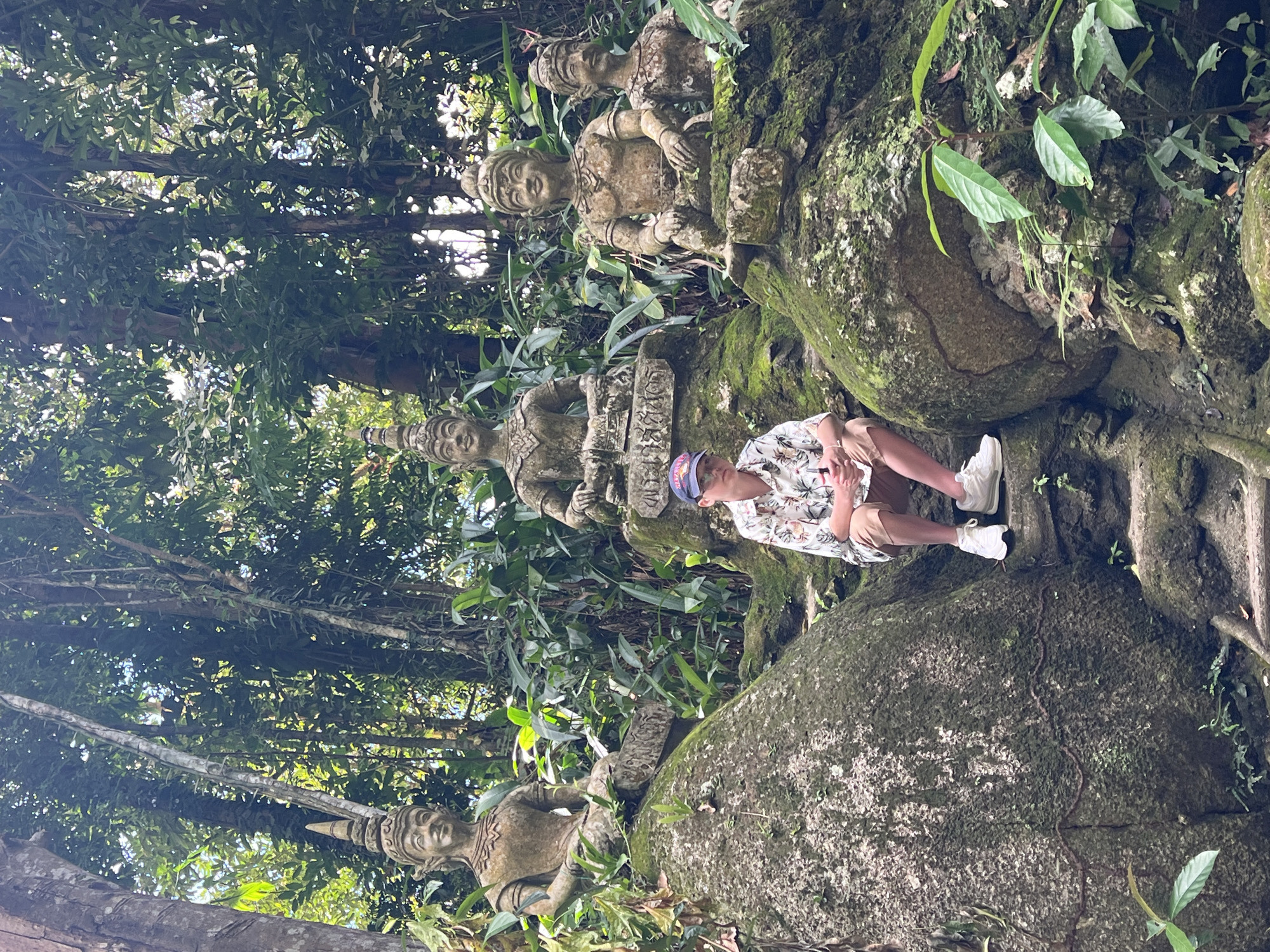 Tourist documents ancient jungle temple ruins in Ko Samui
