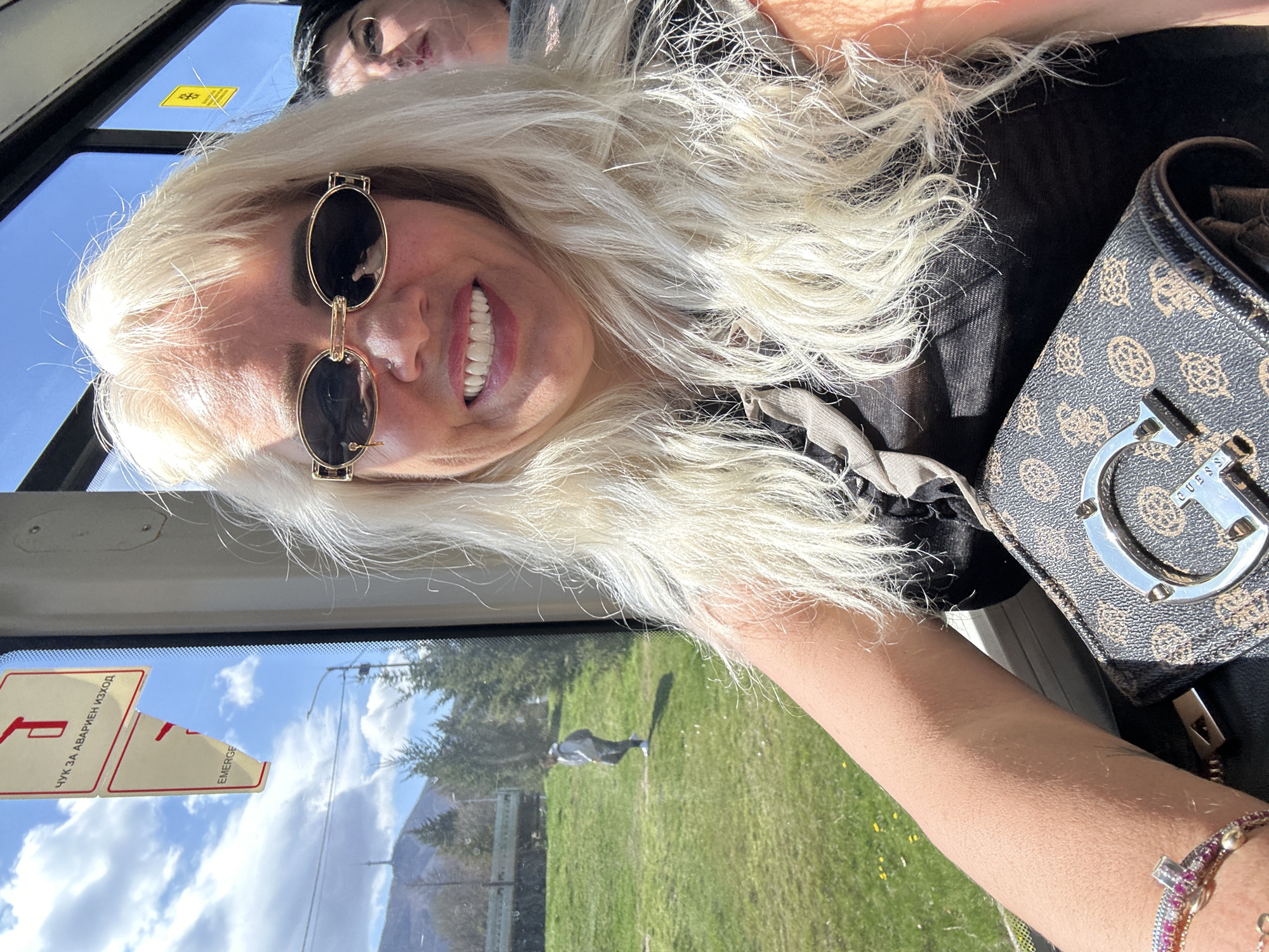 Woman rides public bus in Sofia with mountain views