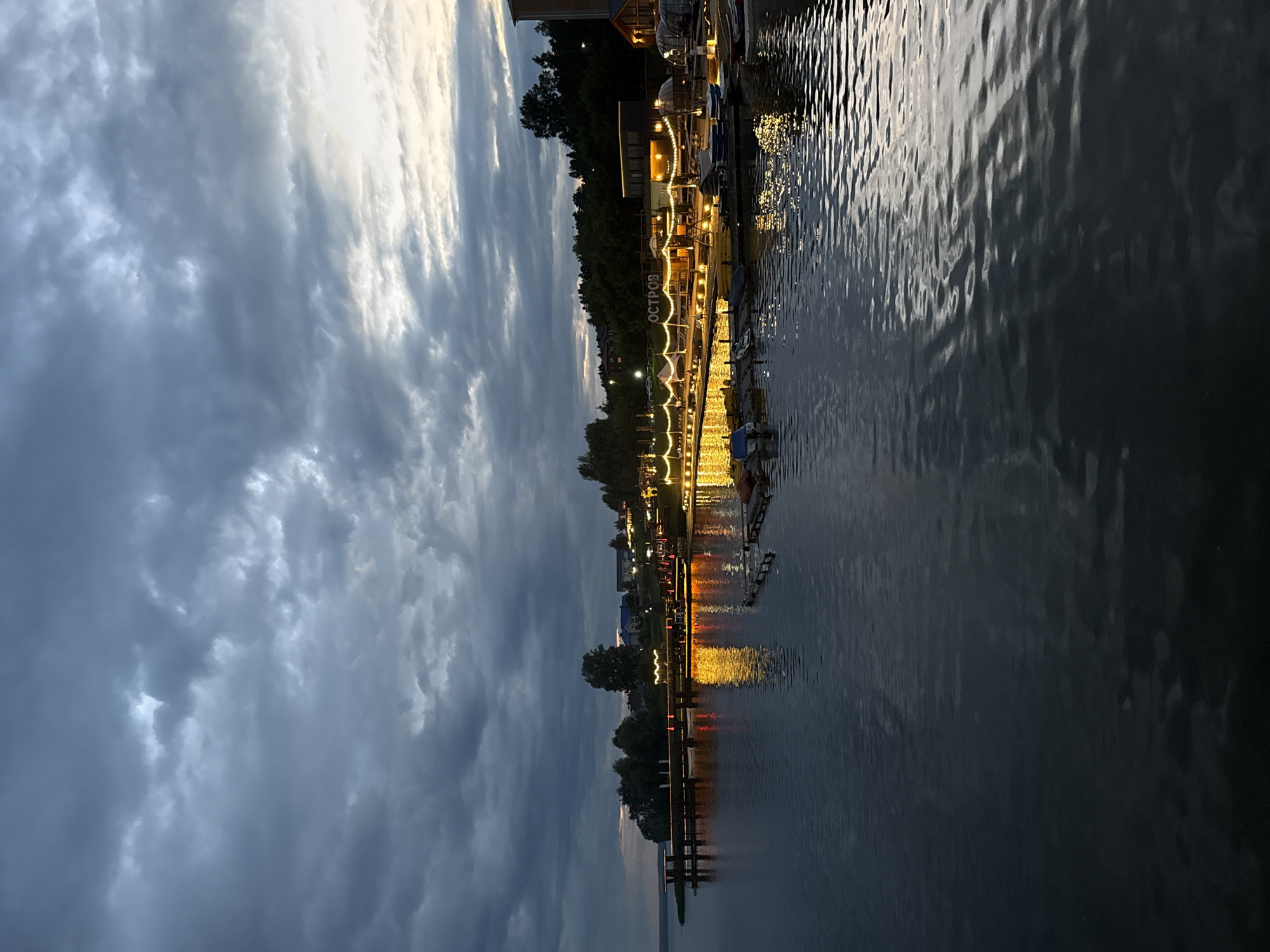 Dusk at the Votkinsk waterfront, clouds and calm water