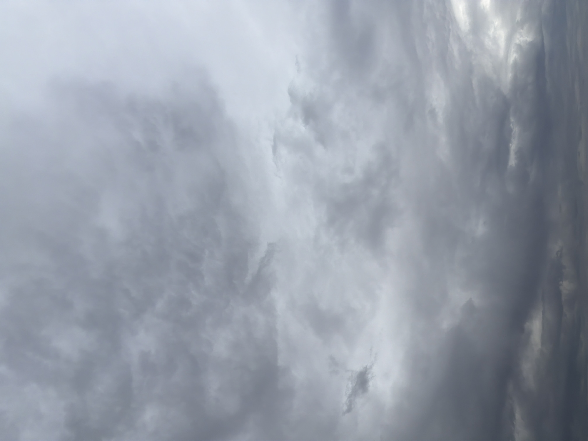 Man fishes Kama River under cloudy skies in Chaikovsky