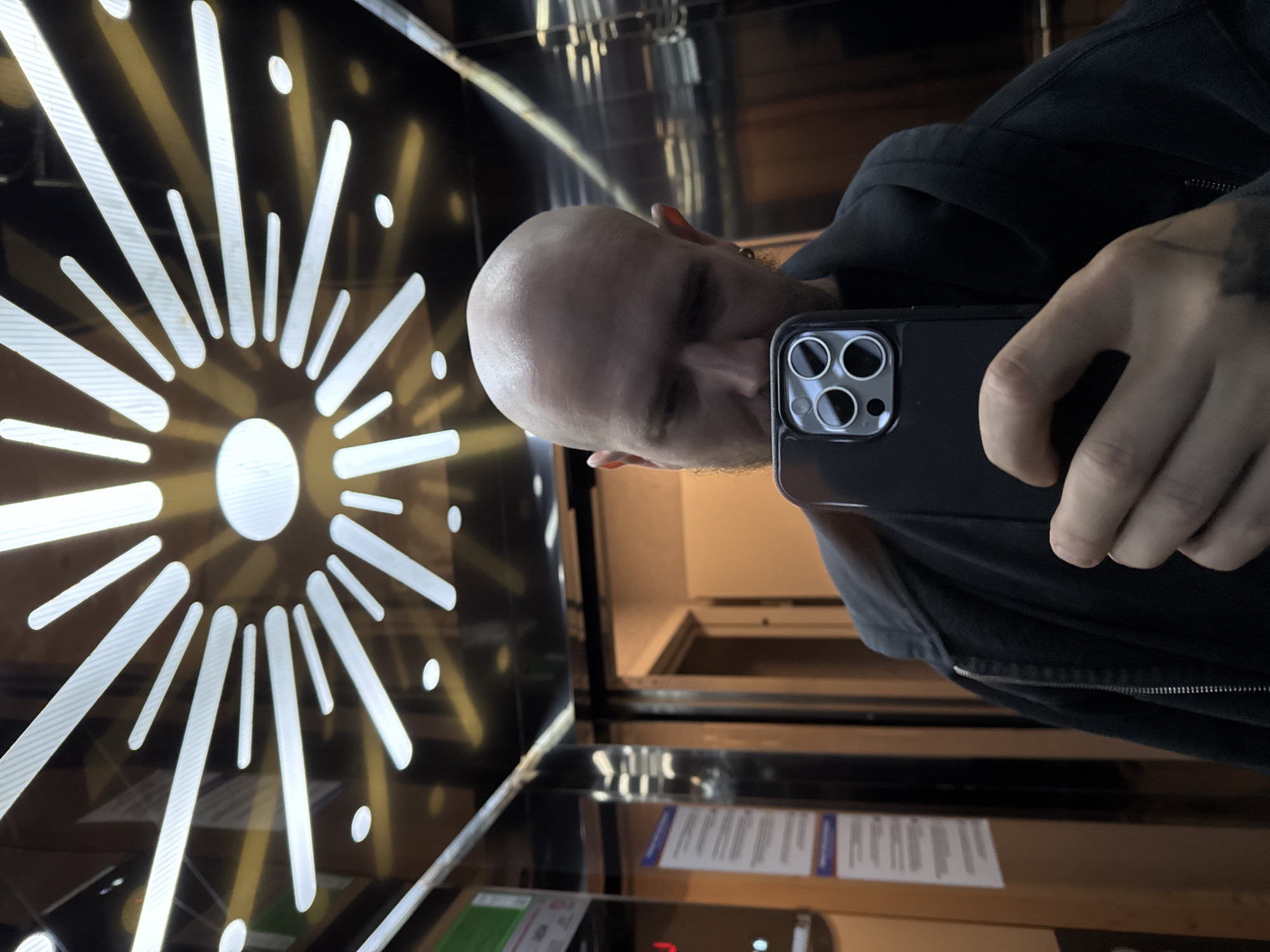 Man takes selfie in geometric mirrored elevator in Turkey