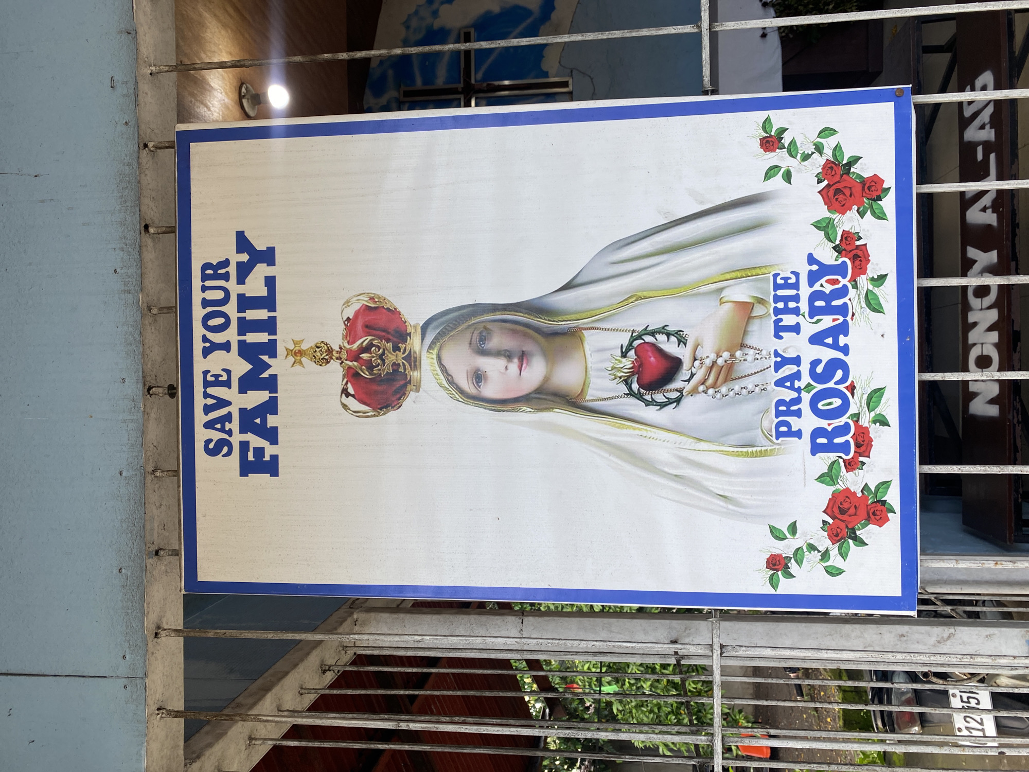 Davao City roadside: street traffic, storefronts, and a roadside shrine