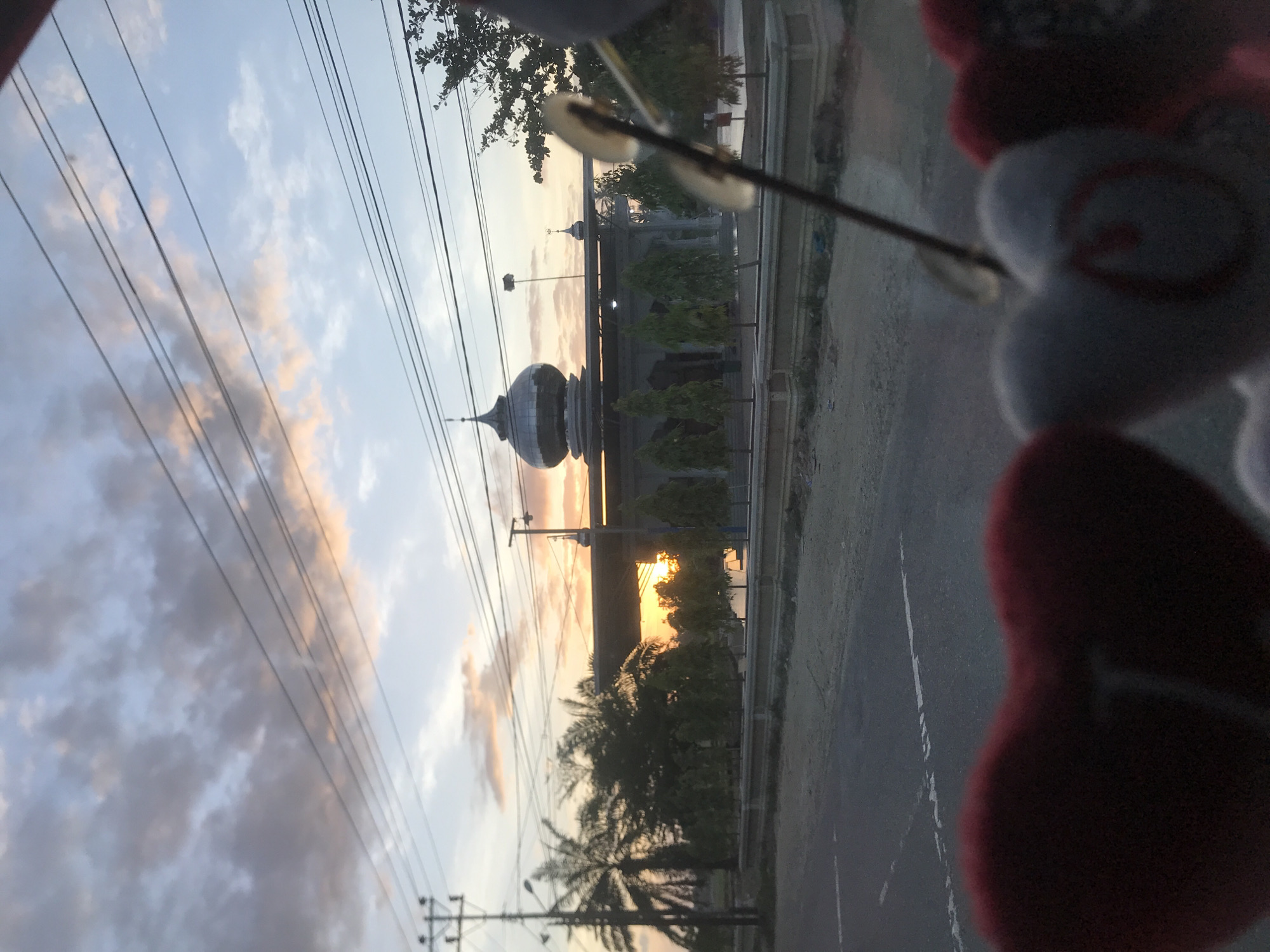 Cityscape photographed through decorated vehicle window in Indonesia