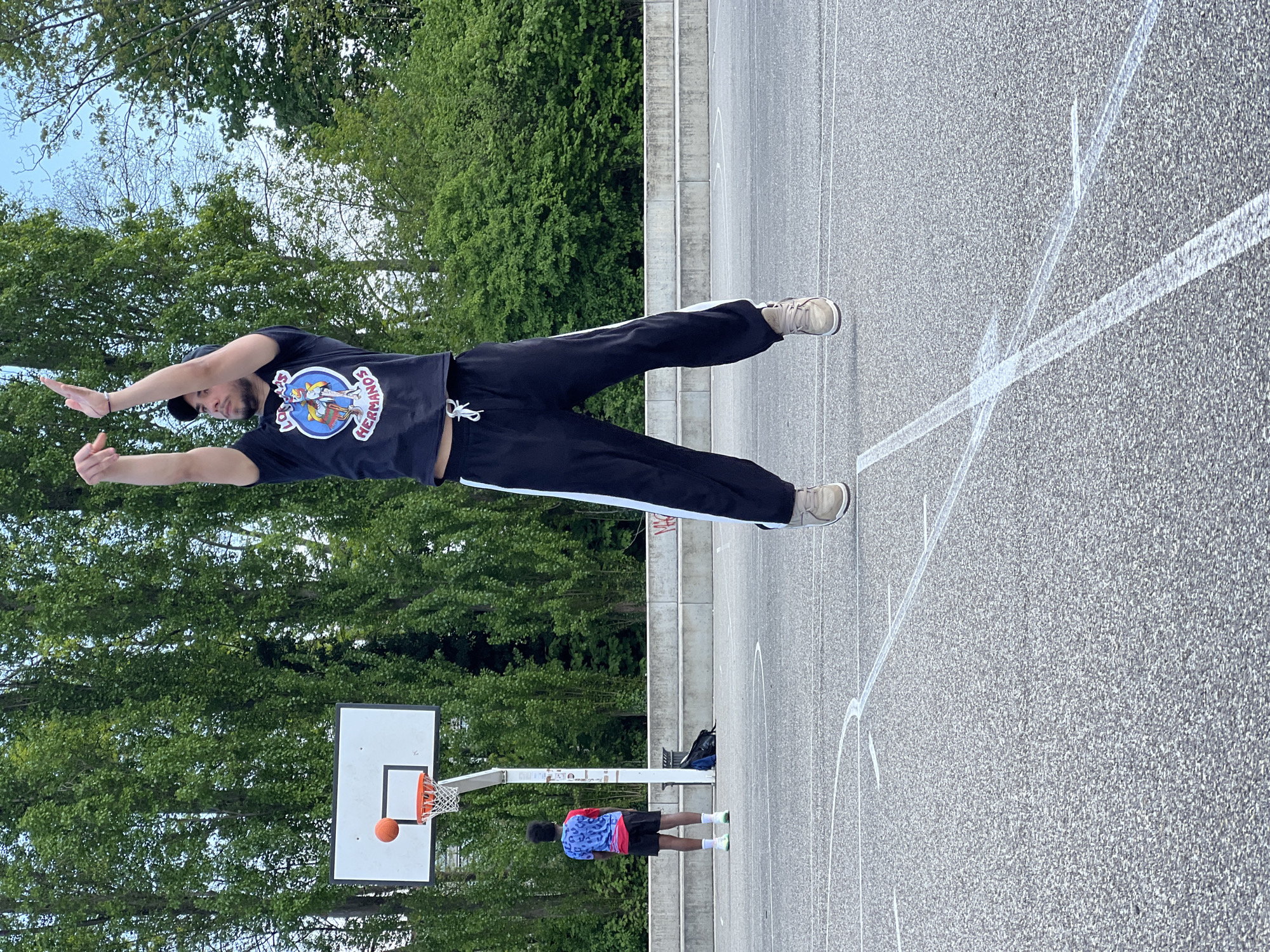 Man stretches at outdoor basketball court in Strasbourg