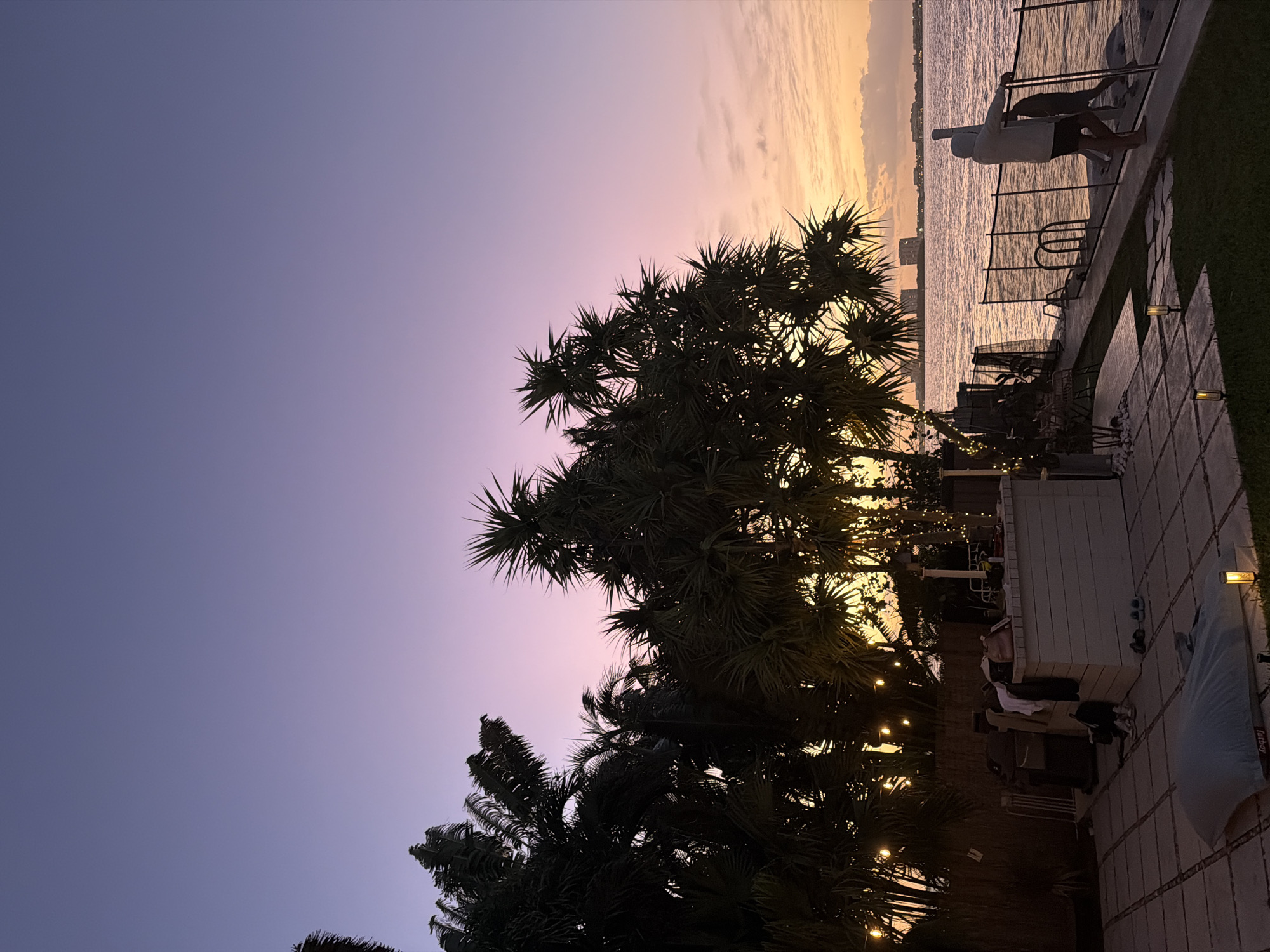 Miami Beach waterfront displays colorful sunset gradient at dusk