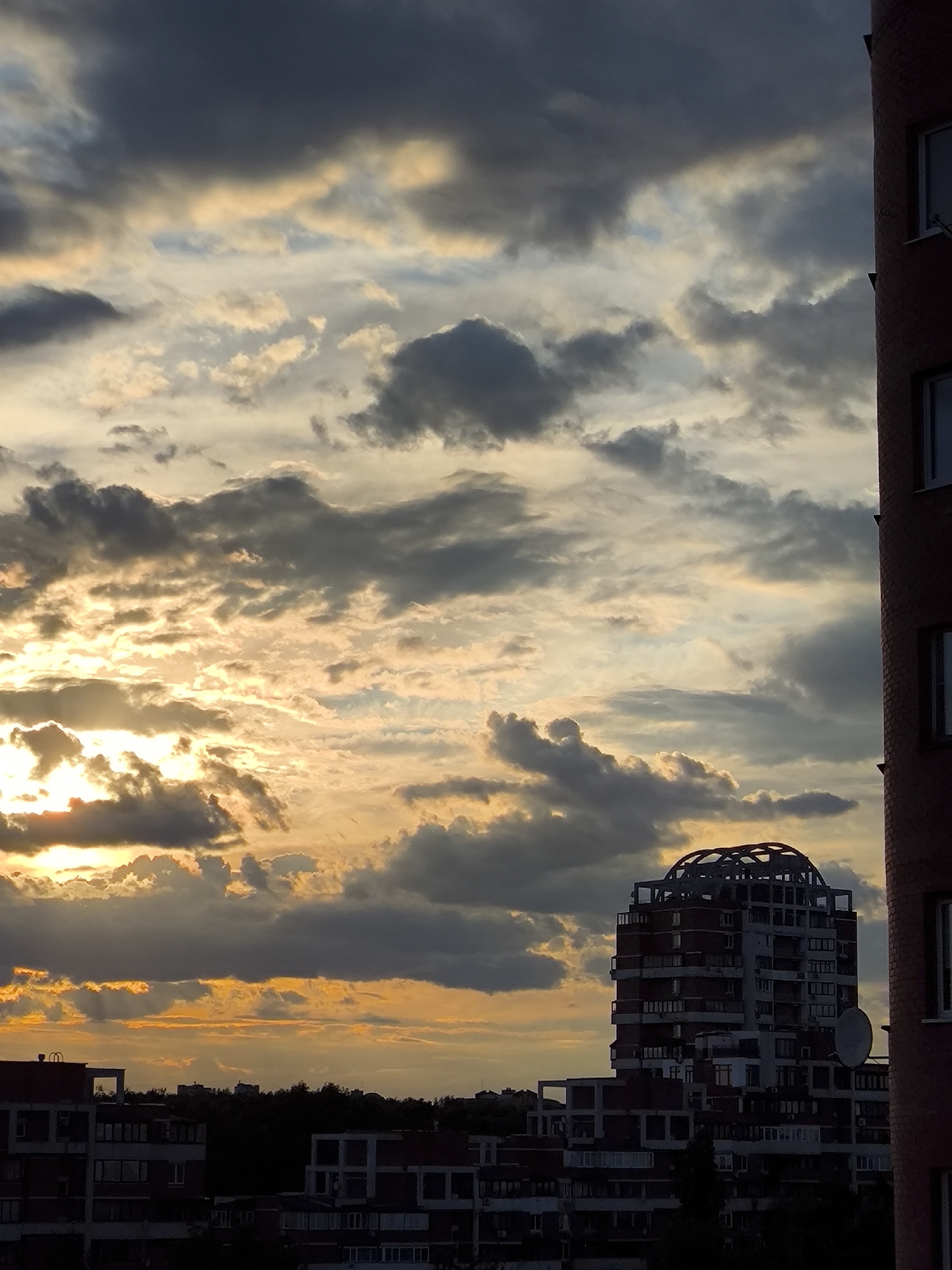 Dramatic sunset captured over urban landscape in sequential photos