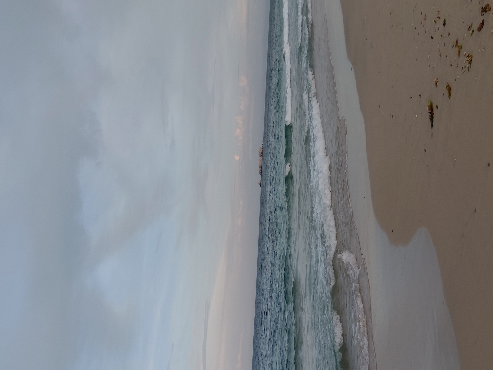 Evening stroll along Pampatar's beach, shells and footprints in tow