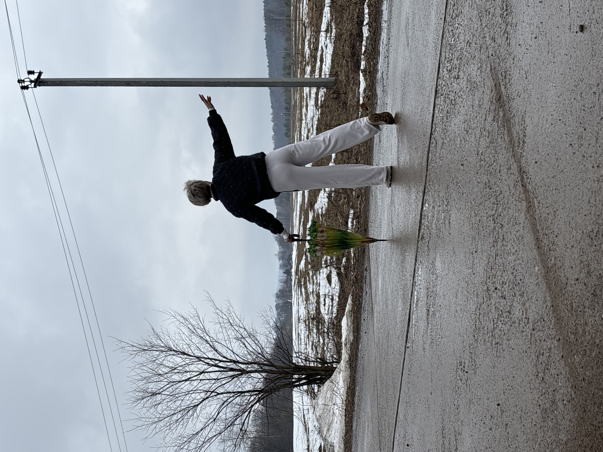 Woman performs yoga pose on street in Noviy, Russia