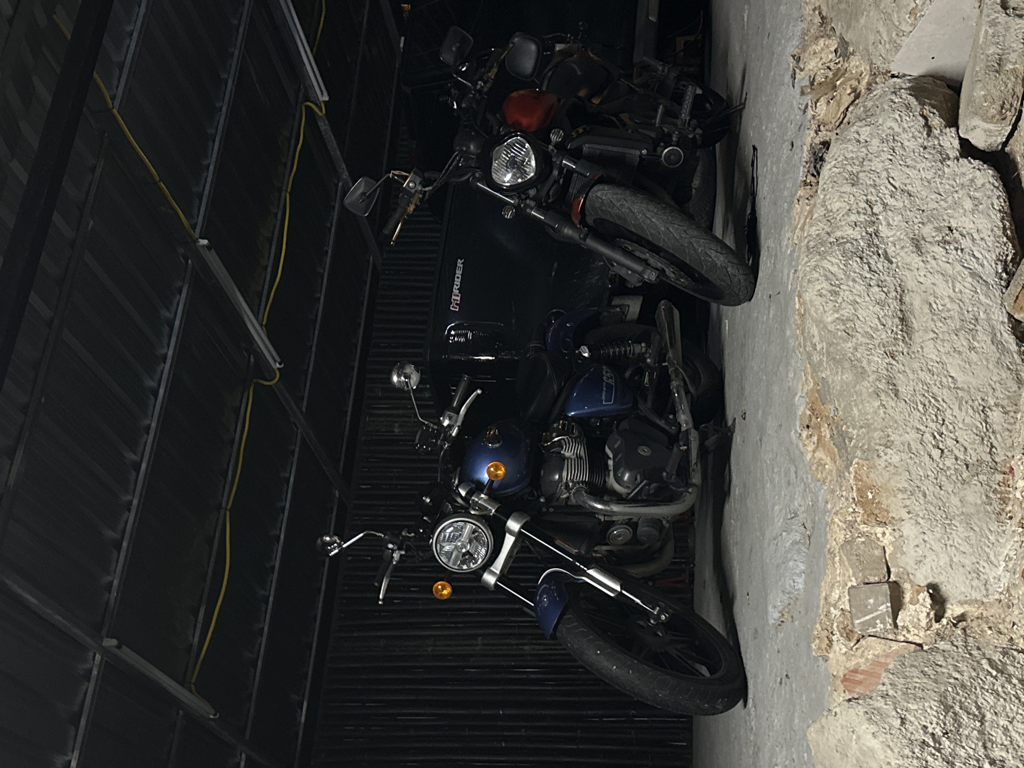 Motorcycles and street life around a Karon garage