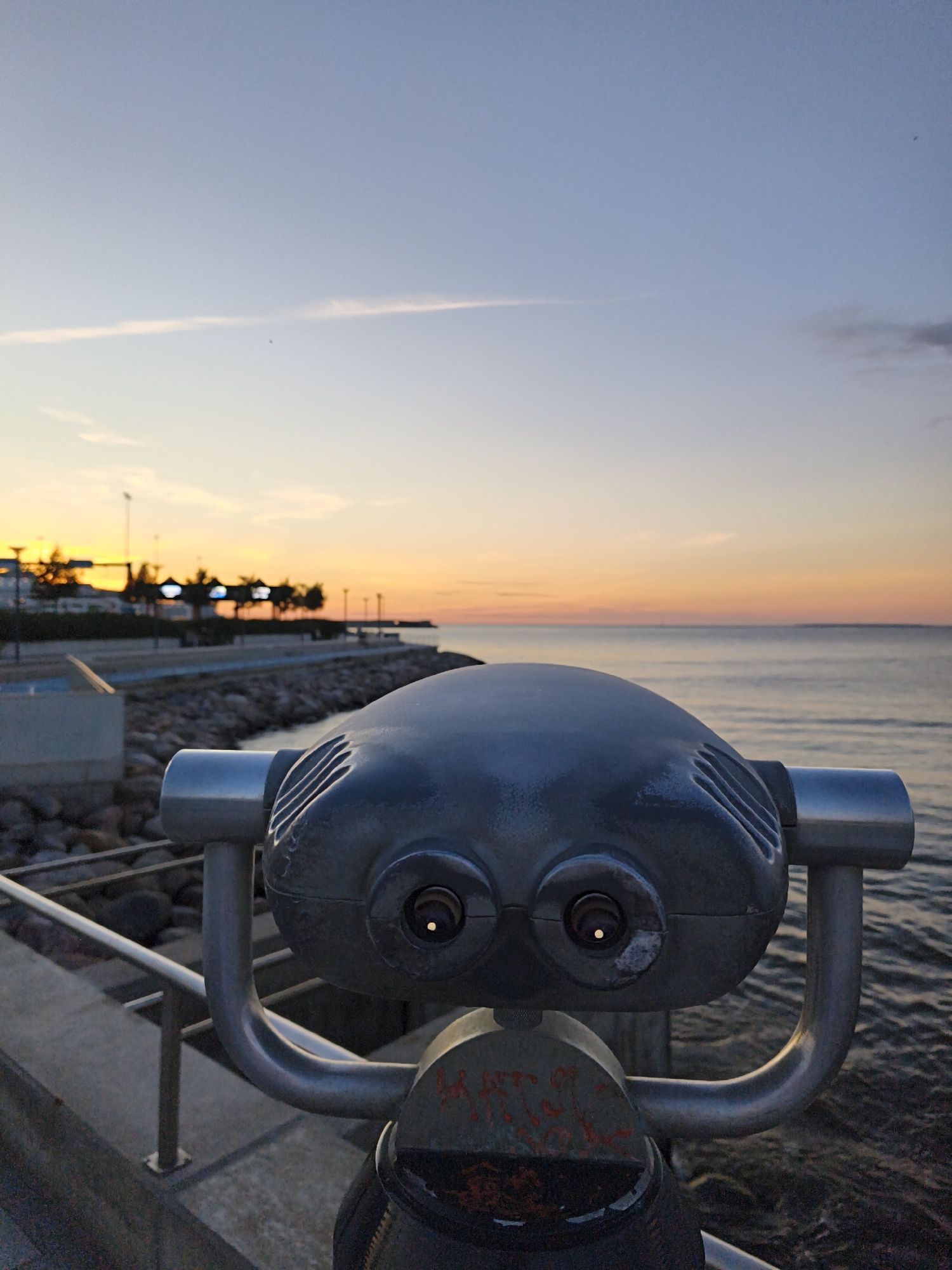 Tallinn waterfront: ferry terminal edge, sunset, binoculars