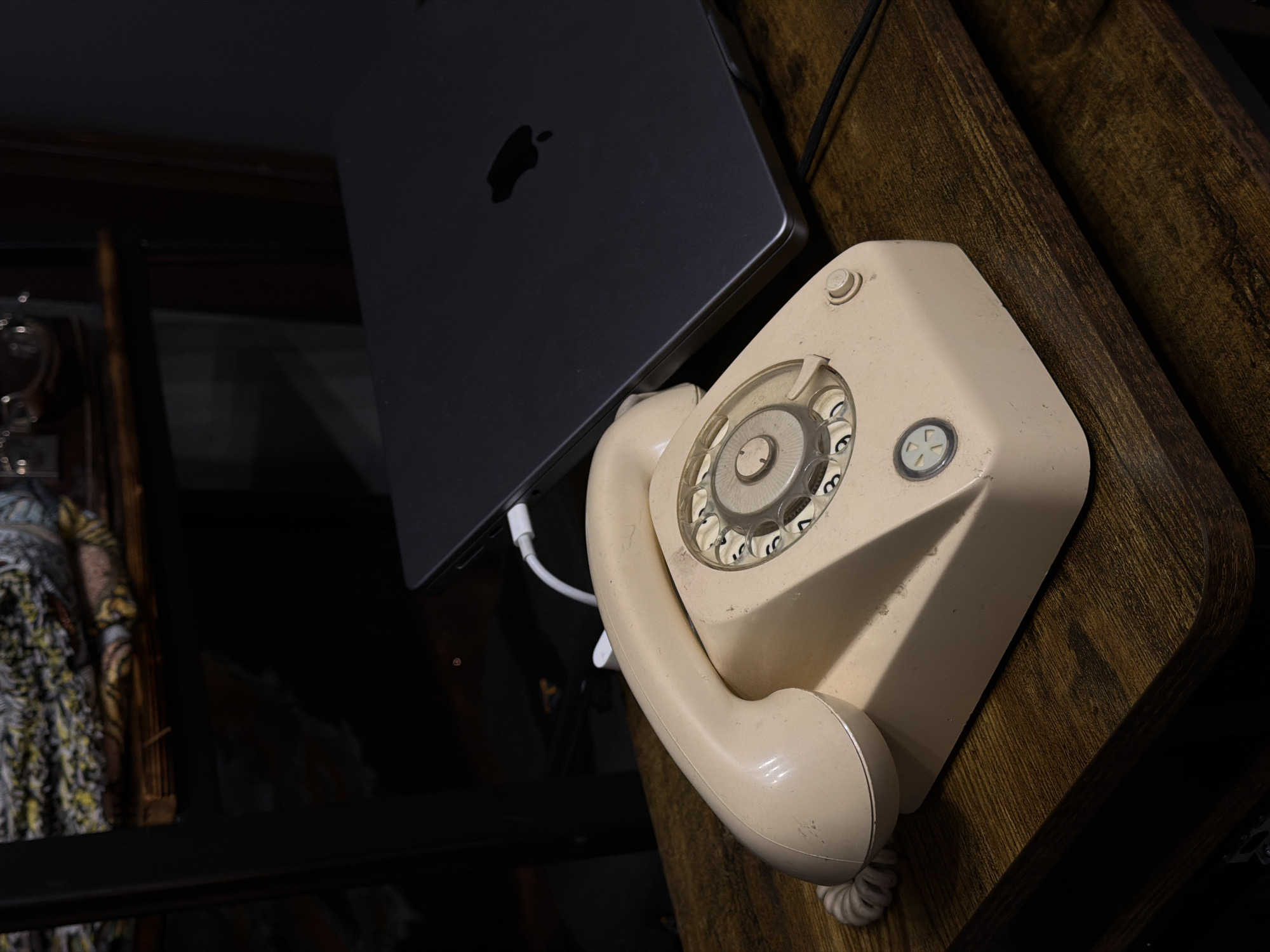 Vintage rotary phone photographed beside modern laptop in Russia
