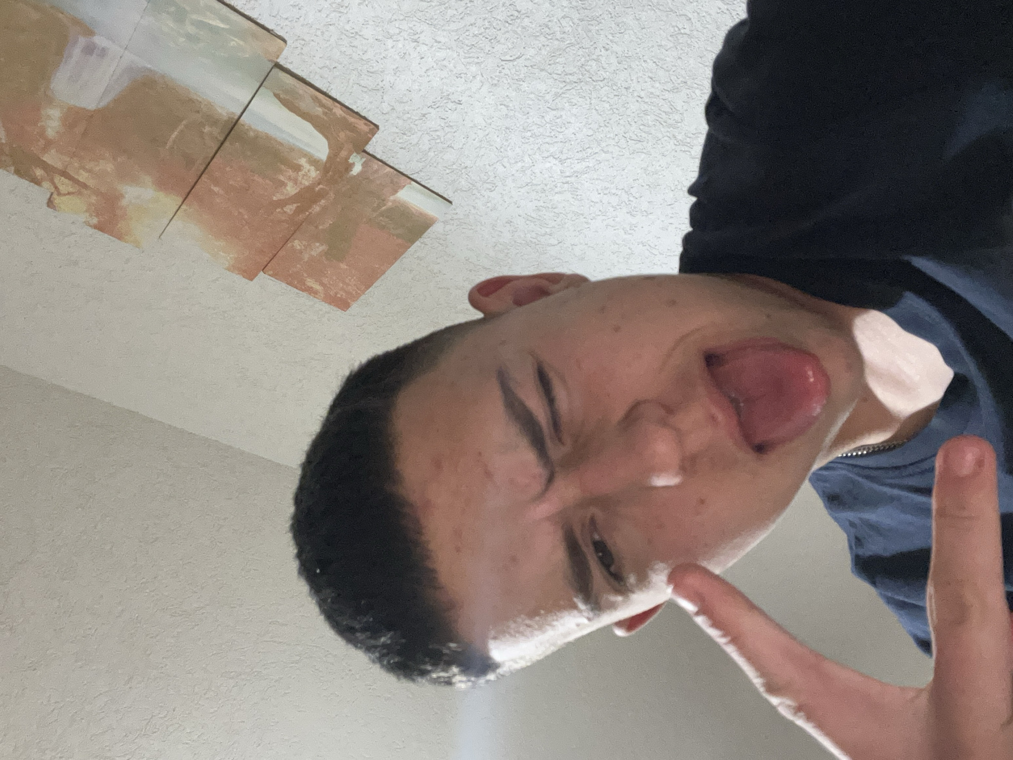 Young man takes playful selfies in Zlatograd bedroom