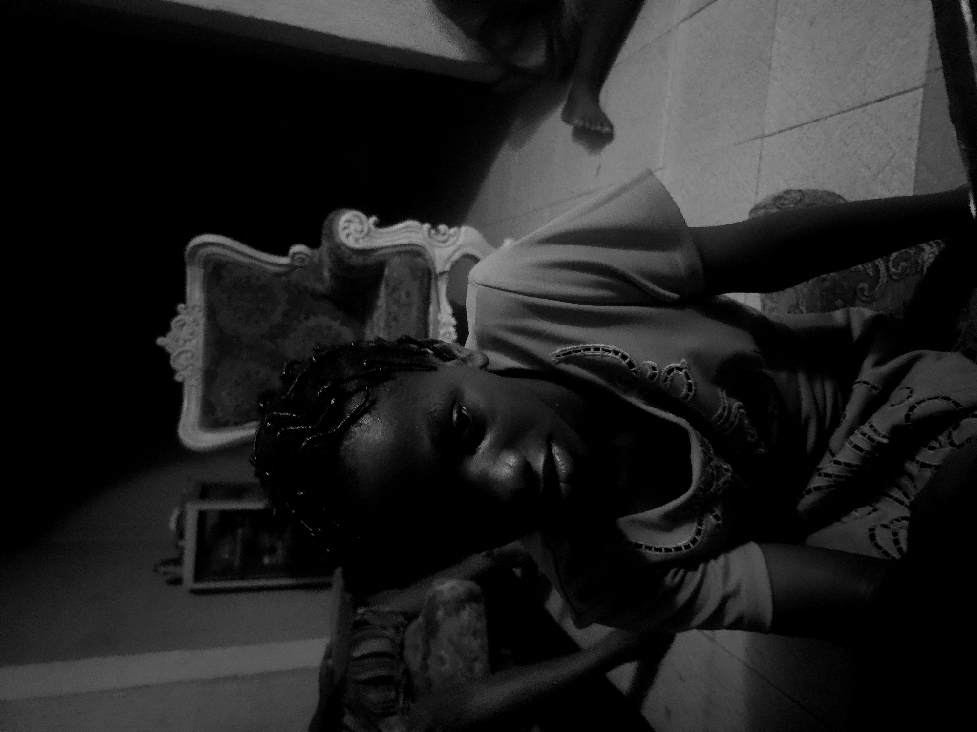 Person photographed in dimly lit indoor scene