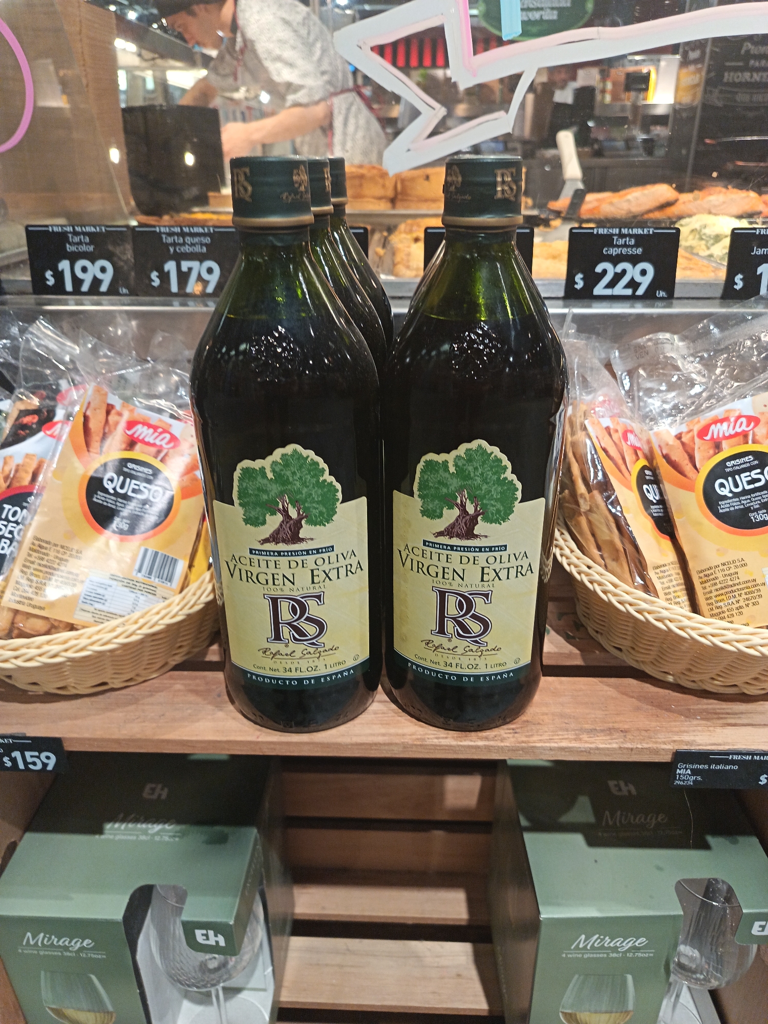 Shopper photographs olive oil bottles in Montevideo supermarket