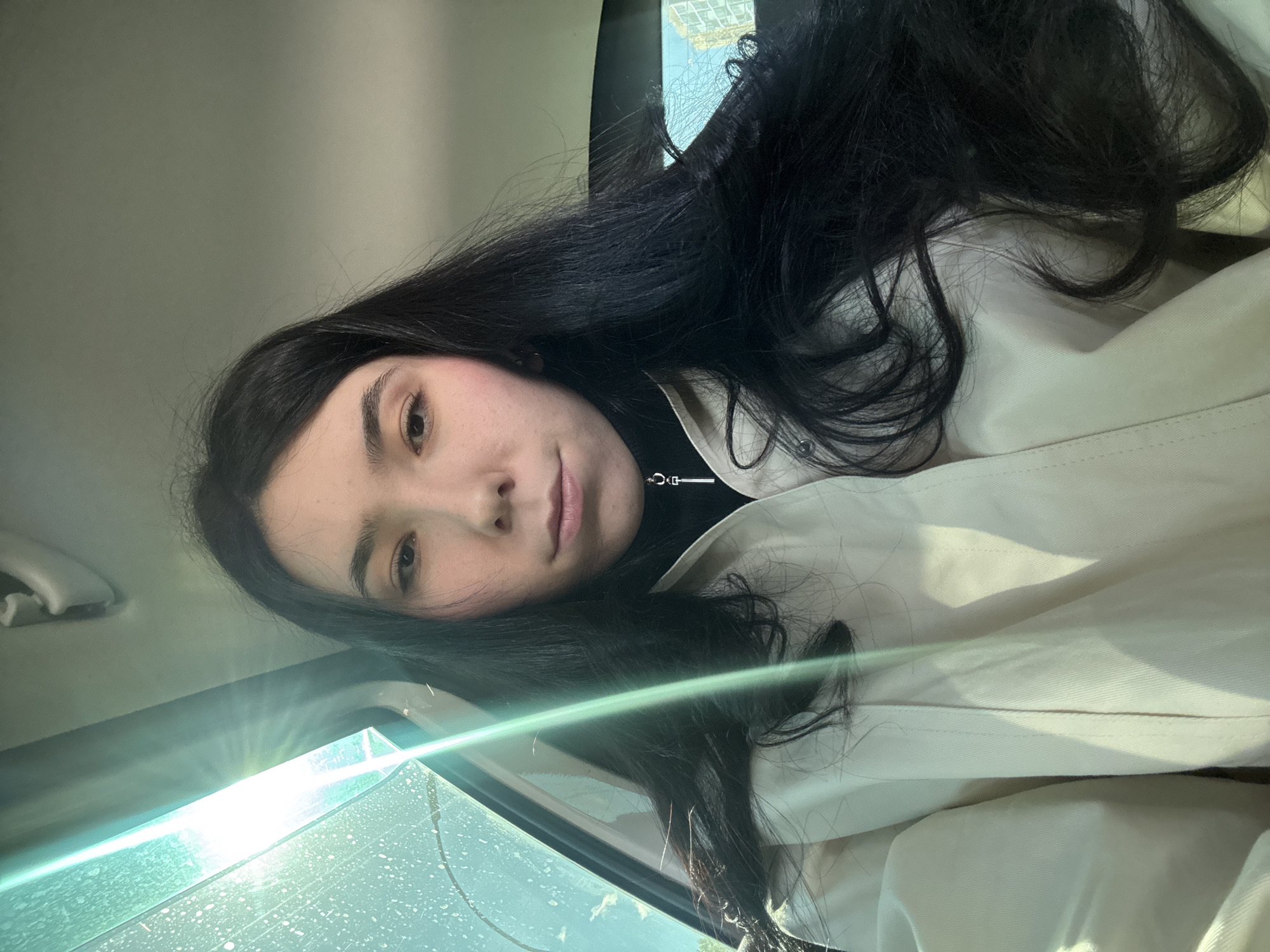 Woman photographed in car during sunny morning in Naberezhnye Chelny
