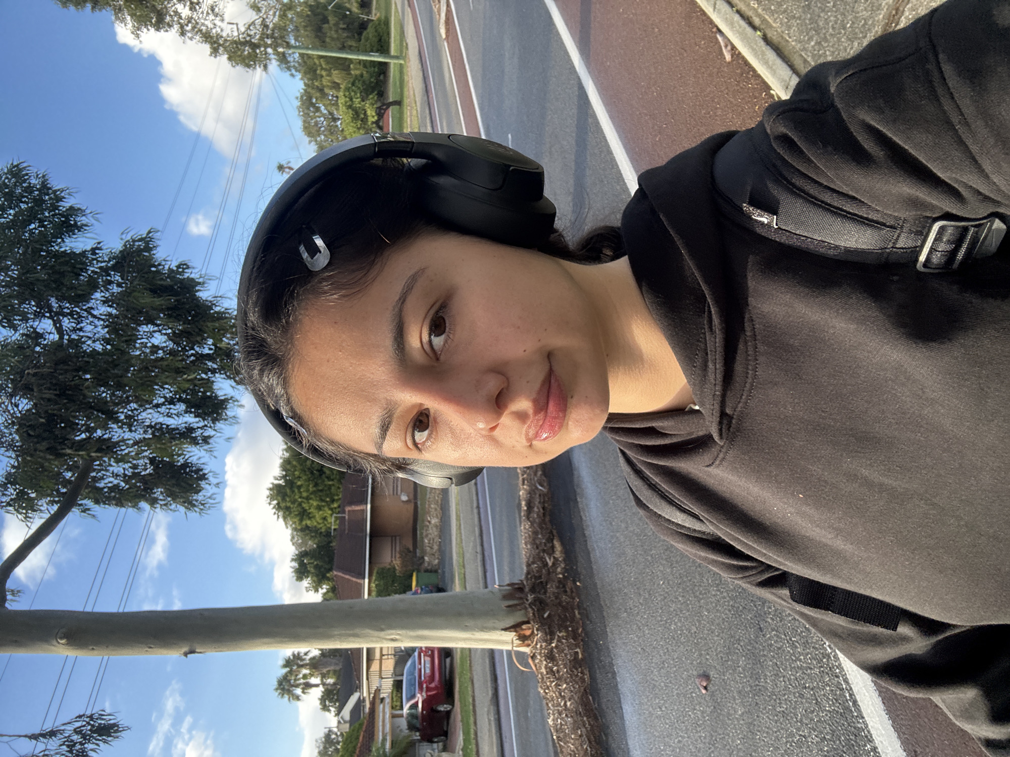 Woman takes evening selfies while walking in Calista suburb