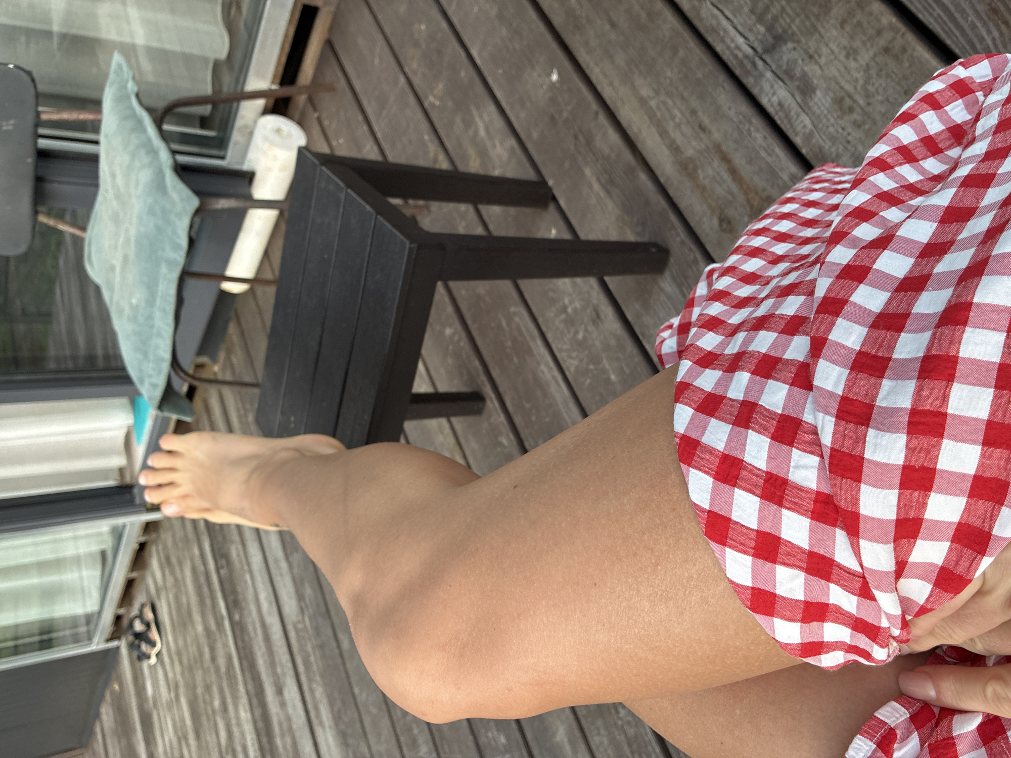 Relaxing on a deck near pink roadside buildings in Arkhipo-Osipovka