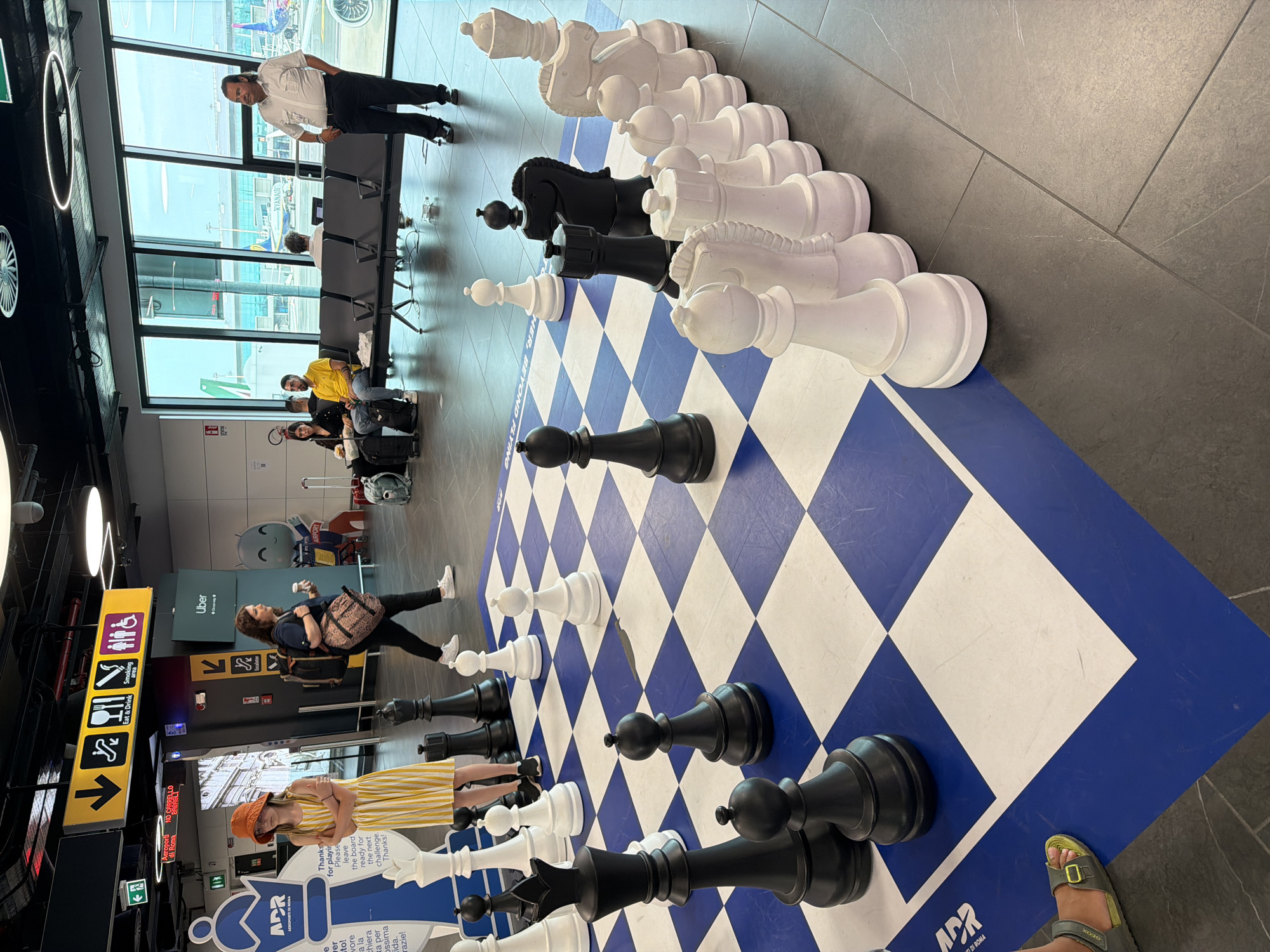 Killing time at Fiumicino with chess sets and tarmac views