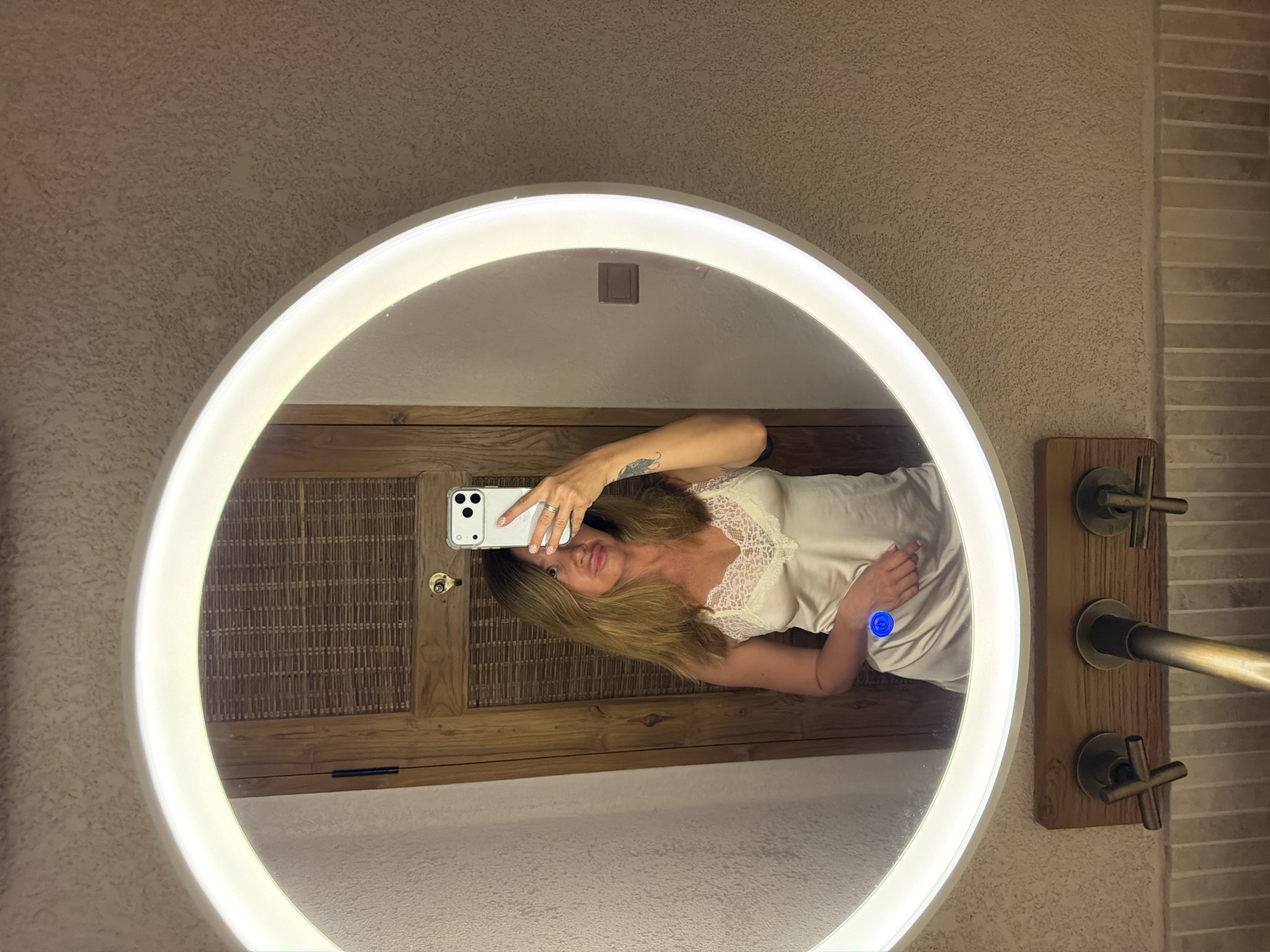 Woman takes bathroom mirror selfies in Mengwi, Indonesia