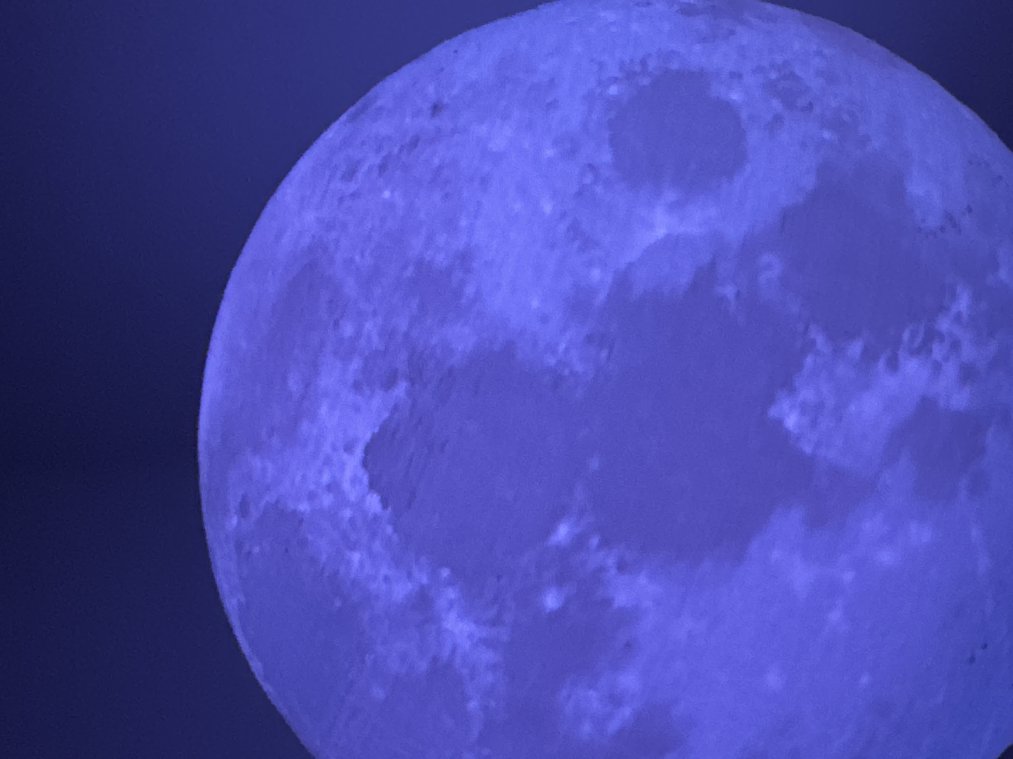 Late-night moon photography session over Lübeck rooftops