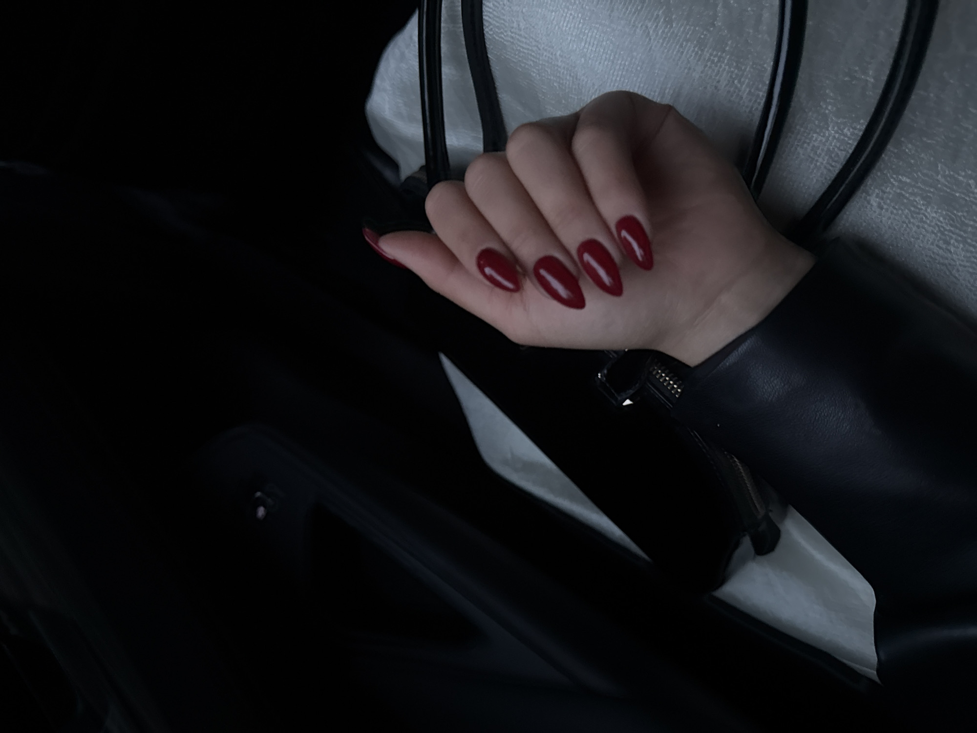 Hand with red nails photographed in vehicle, Yerevan