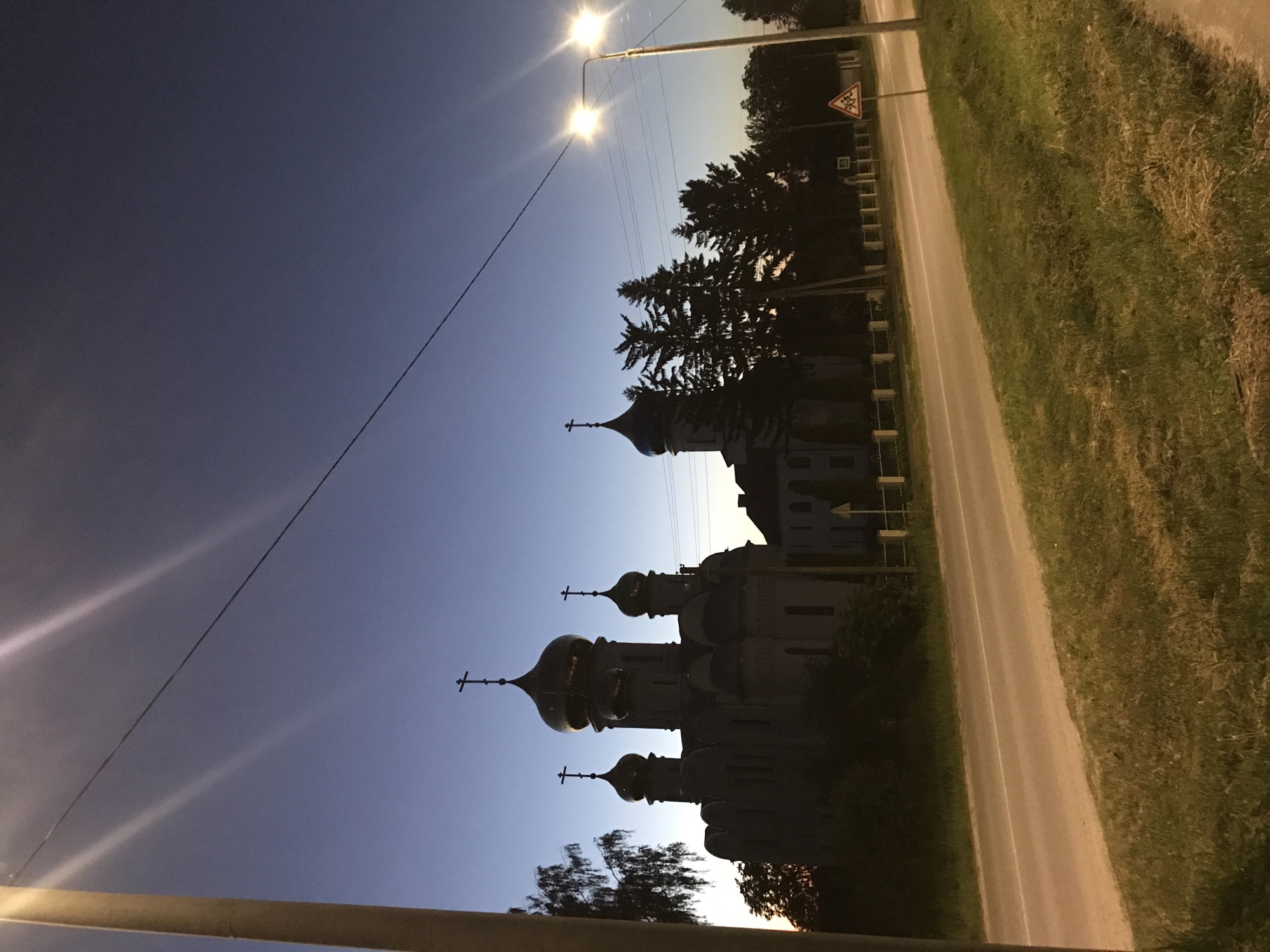 Orthodox church with blue domes photographed at dusk in Lanivtsi