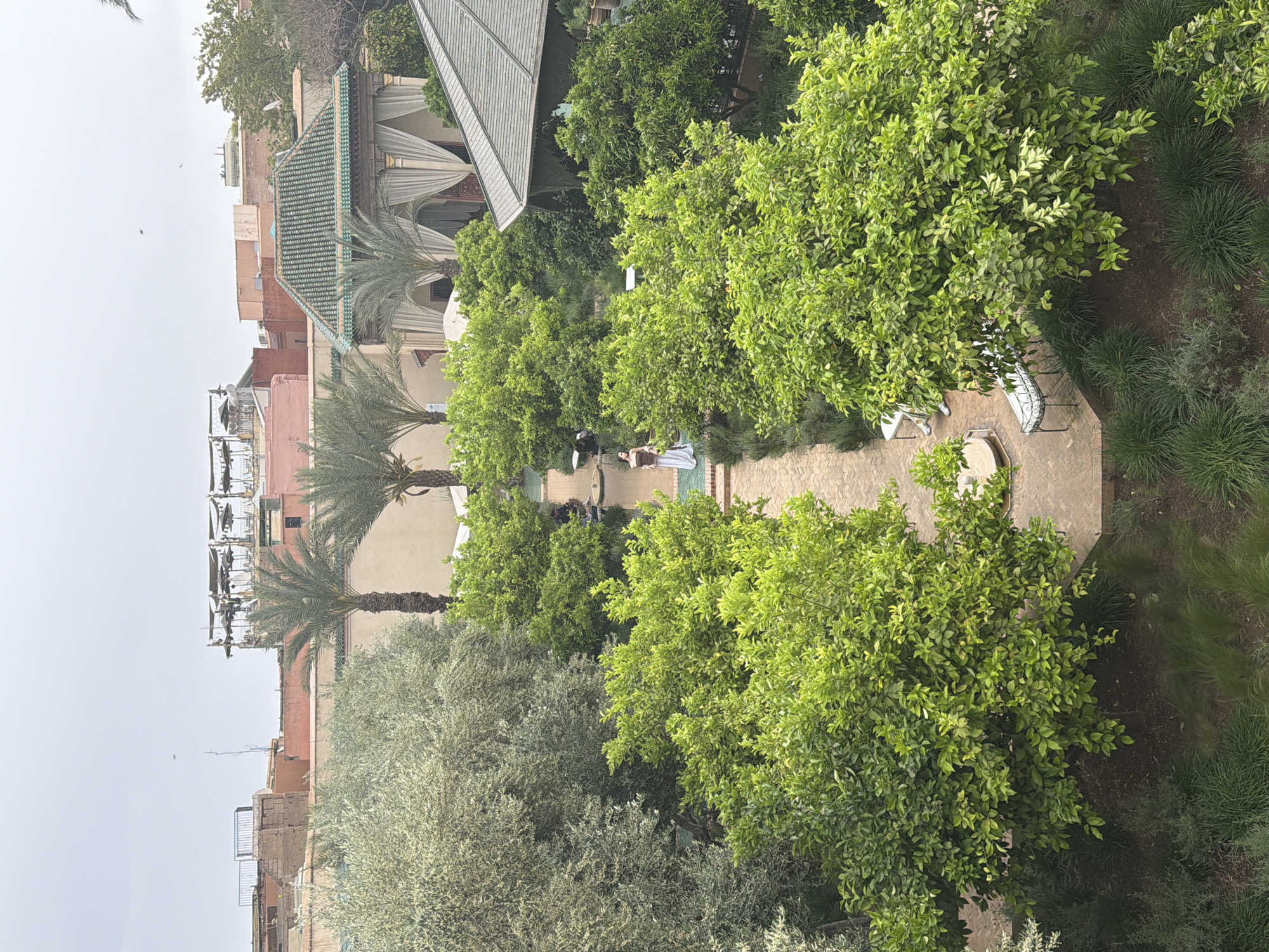 Visitor captures garden views and tile details at Marrakesh attraction