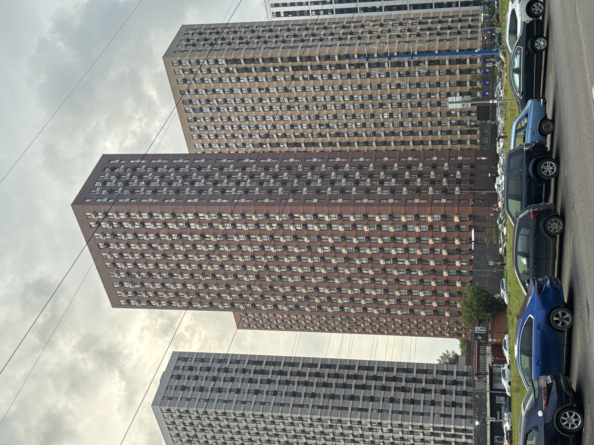 Modern apartment blocks line a Dolgoprudny residential street