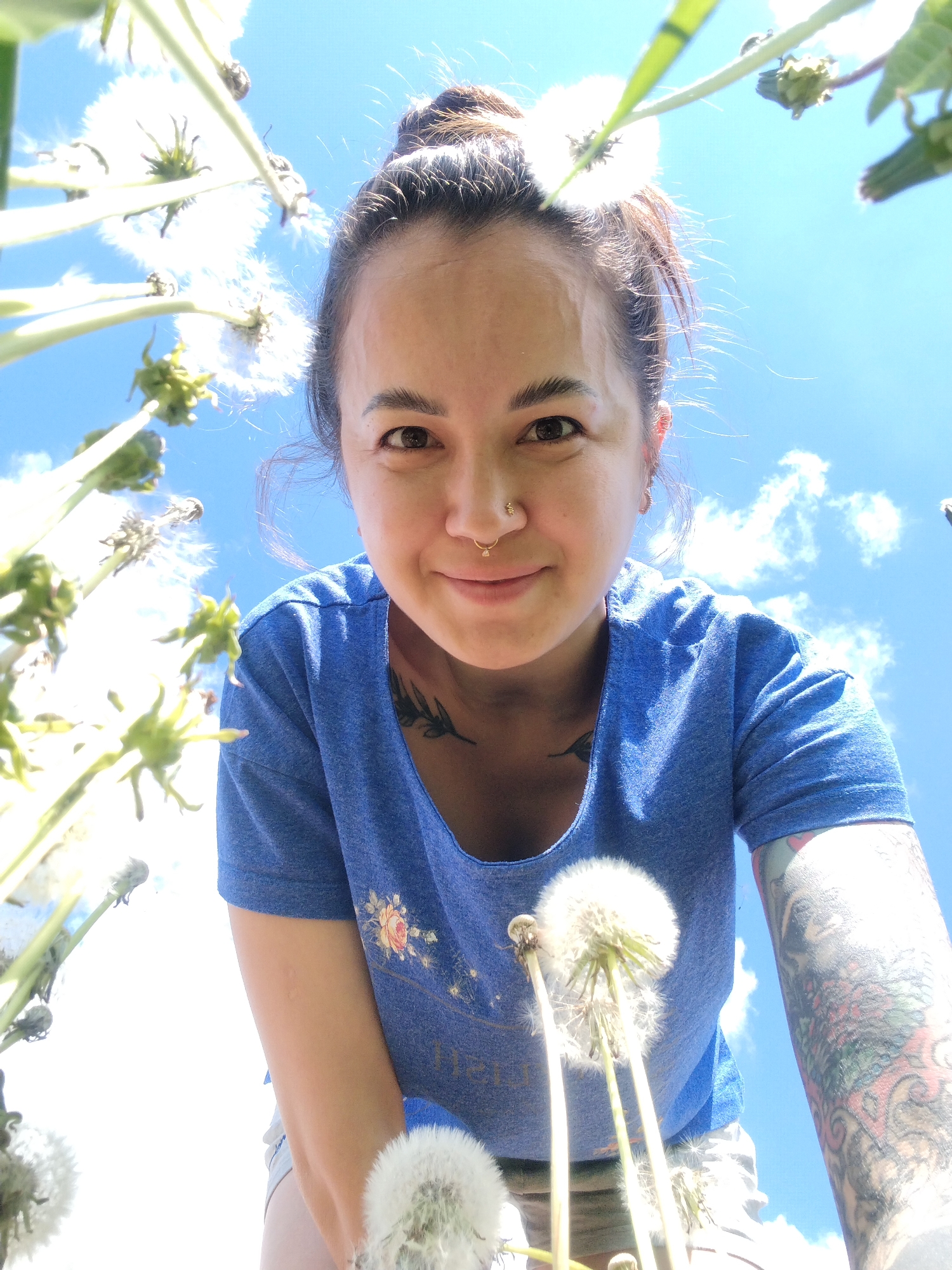 Woman documents spring dandelion field in rural Russia