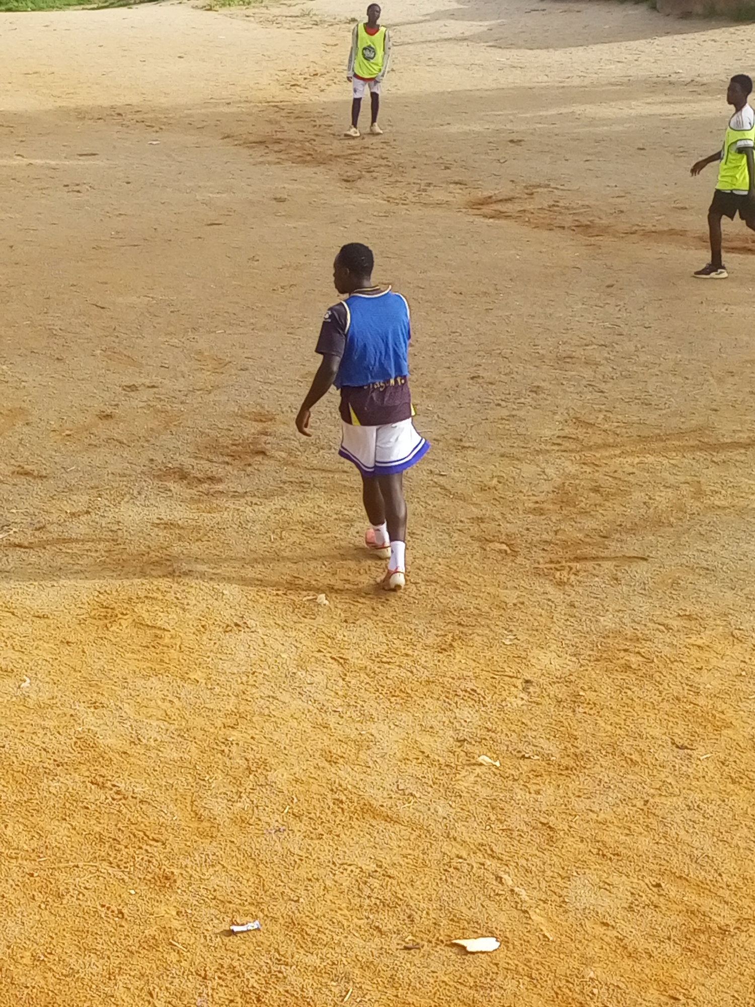 Pickup football on a rocky dirt pitch in Jos, Nigeria