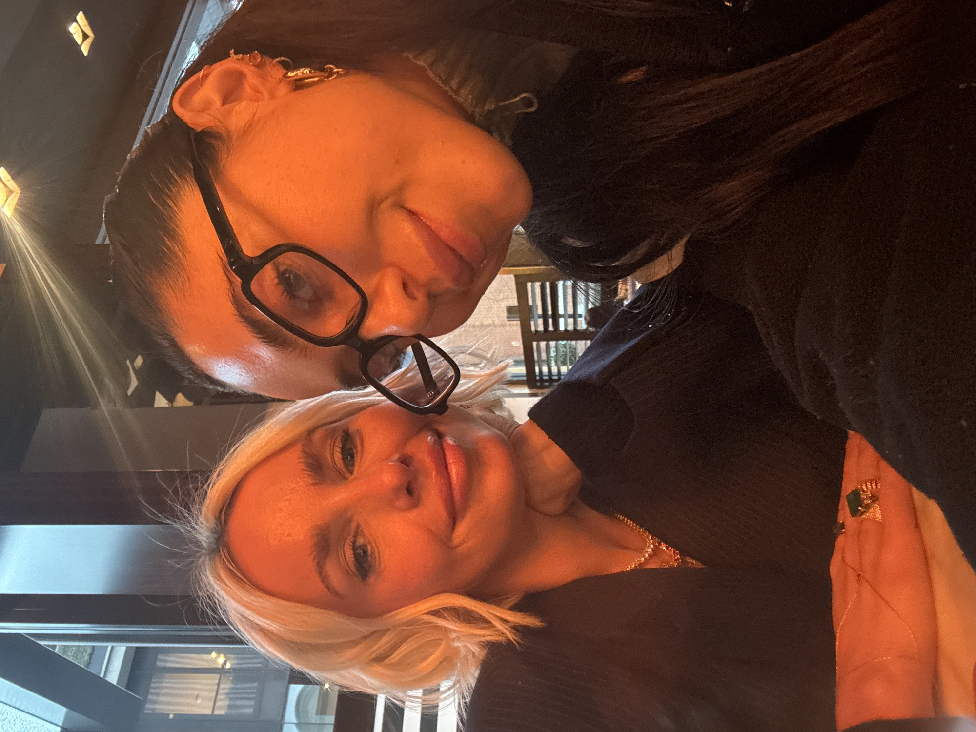 Two women take selfies at London restaurant