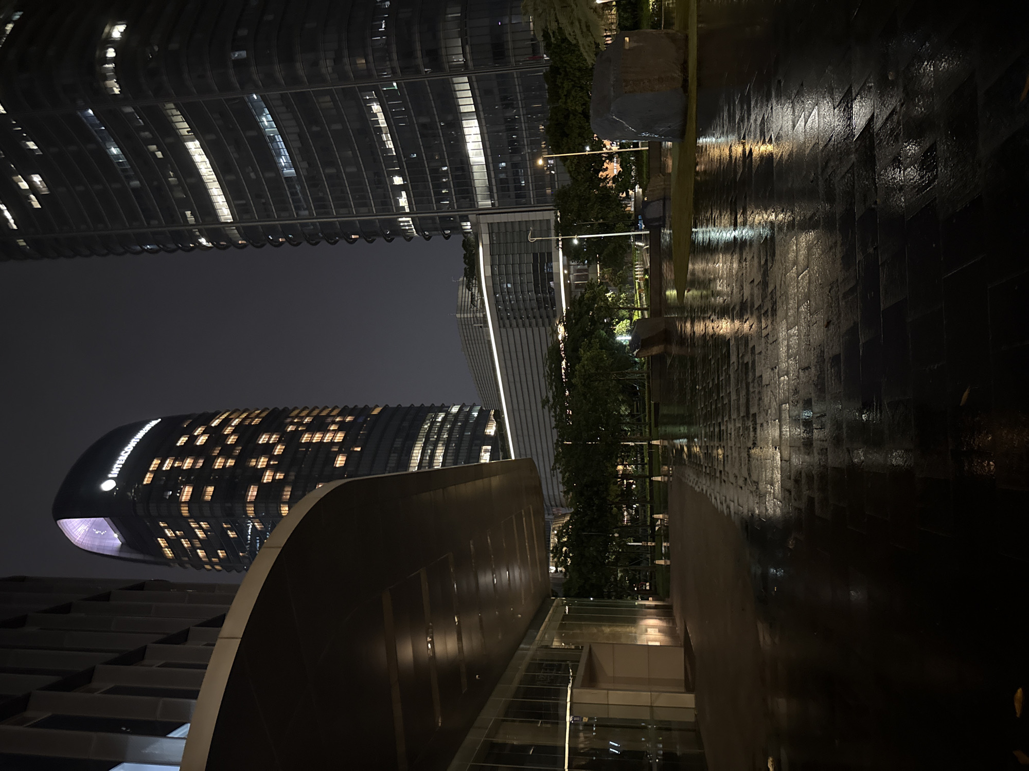 Rainy night walk through Haizhu District's modern urban core