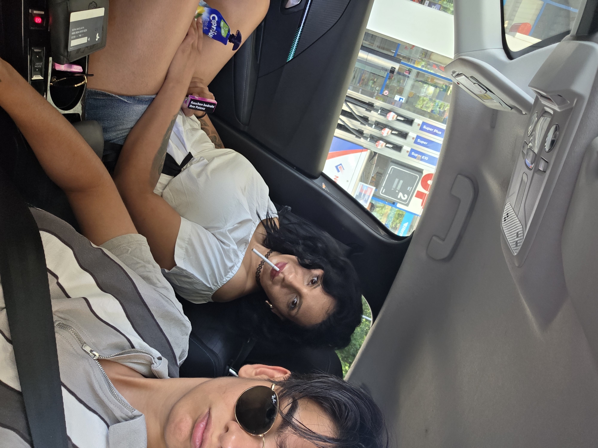 Passenger goofs for the camera at a German gas station