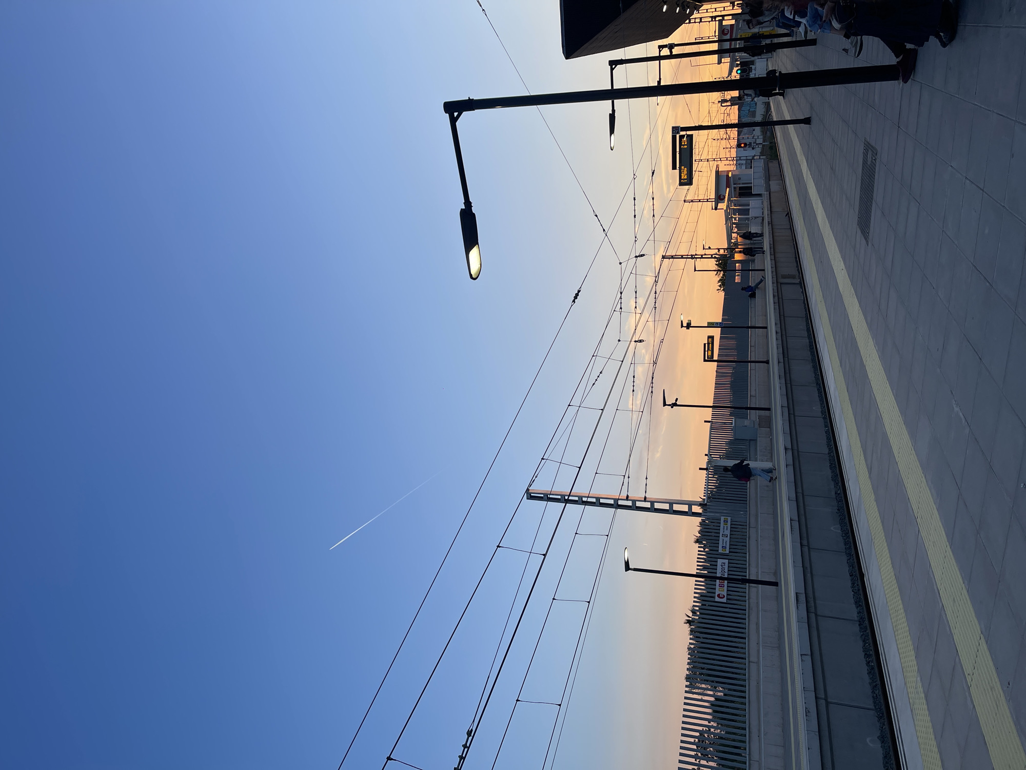 Morning commuter walks Paiporta metro platform at sunrise