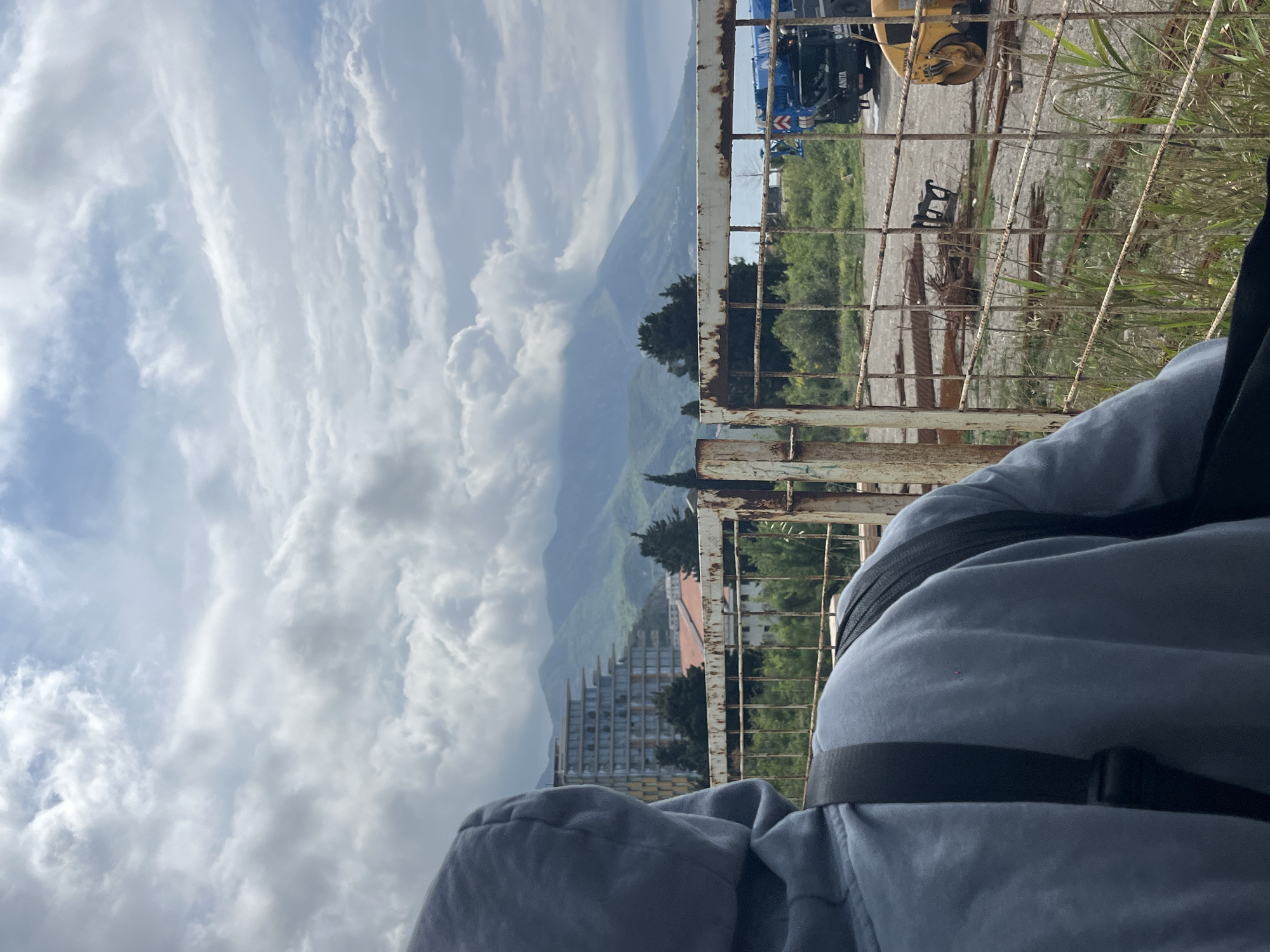 Person views scenic landscape through fence in Boreti, Montenegro