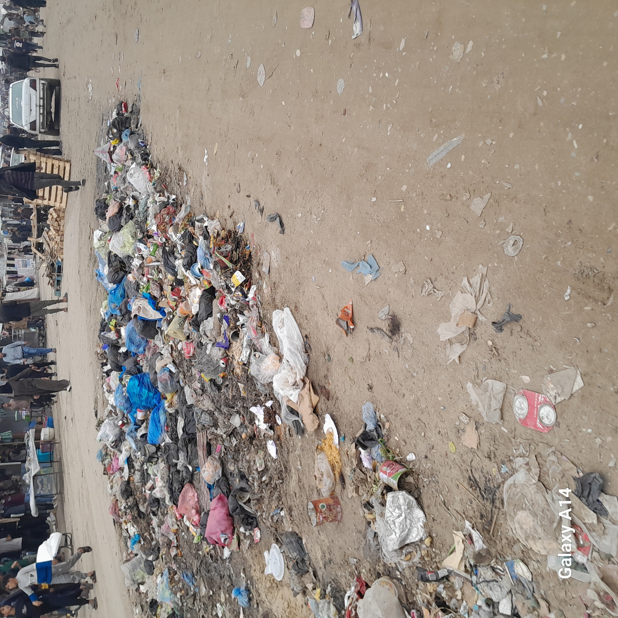 Pedestrians navigate trash-strewn streets in Khan Yunis