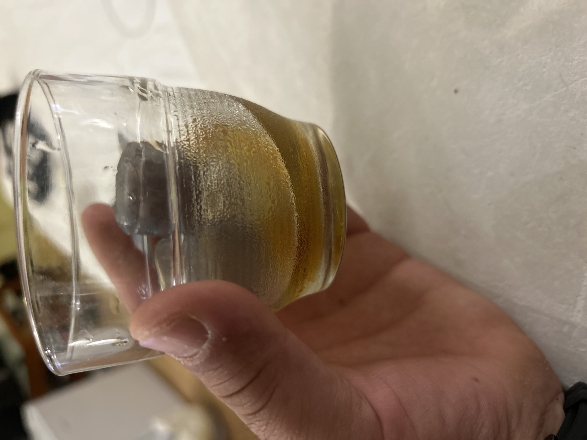 Person holds iced amber drink in Sveti Vlas, Bulgaria