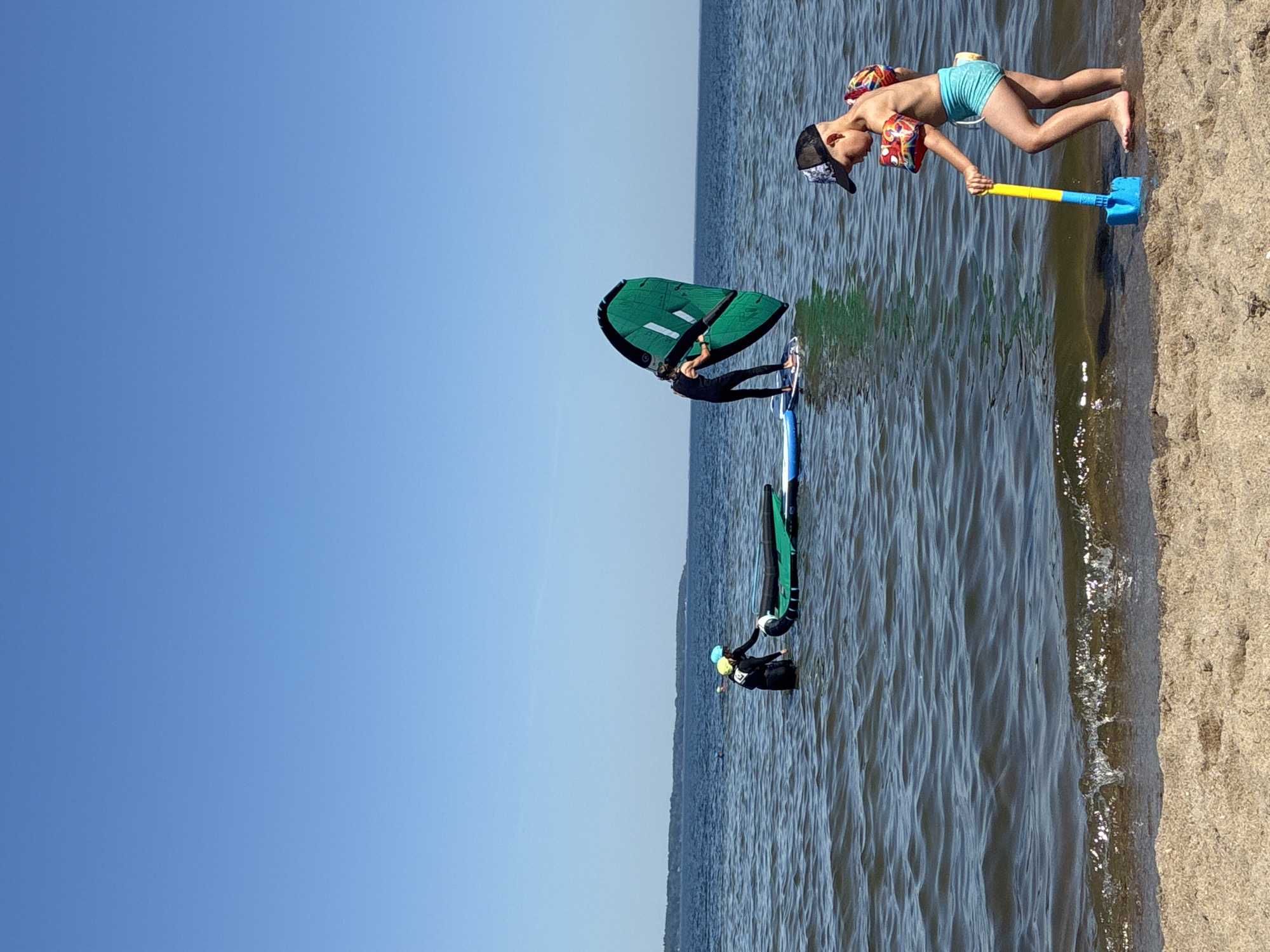 Busy summer morning at Rewa beach: water sports and shoreside relaxing