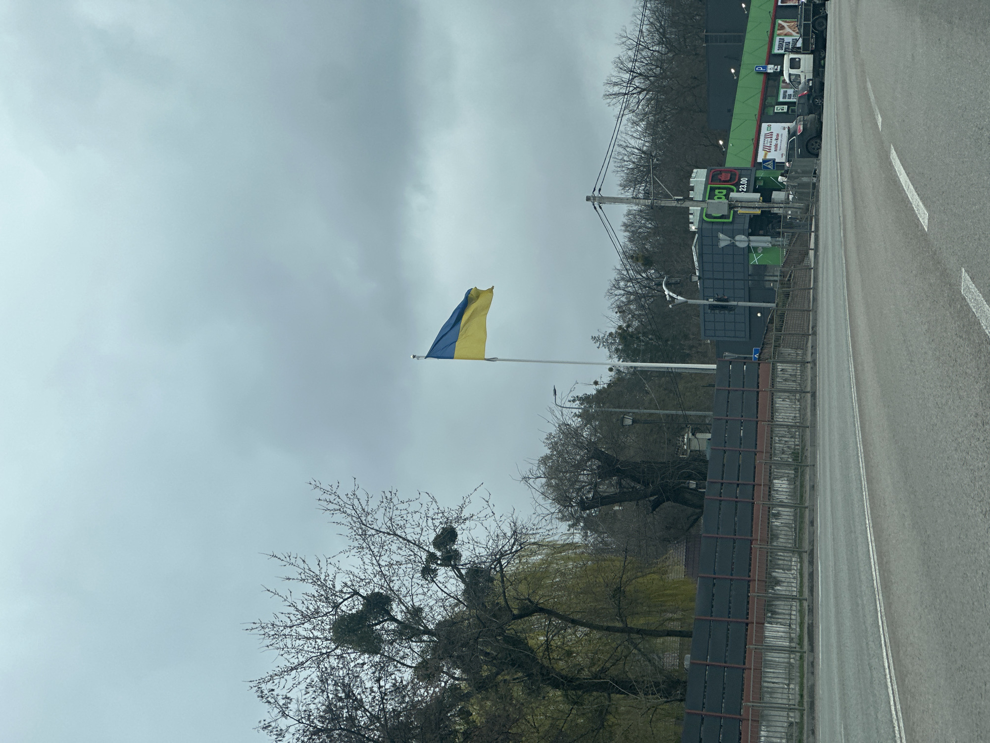 Ukrainian flag flies near damaged buildings in Ukraine