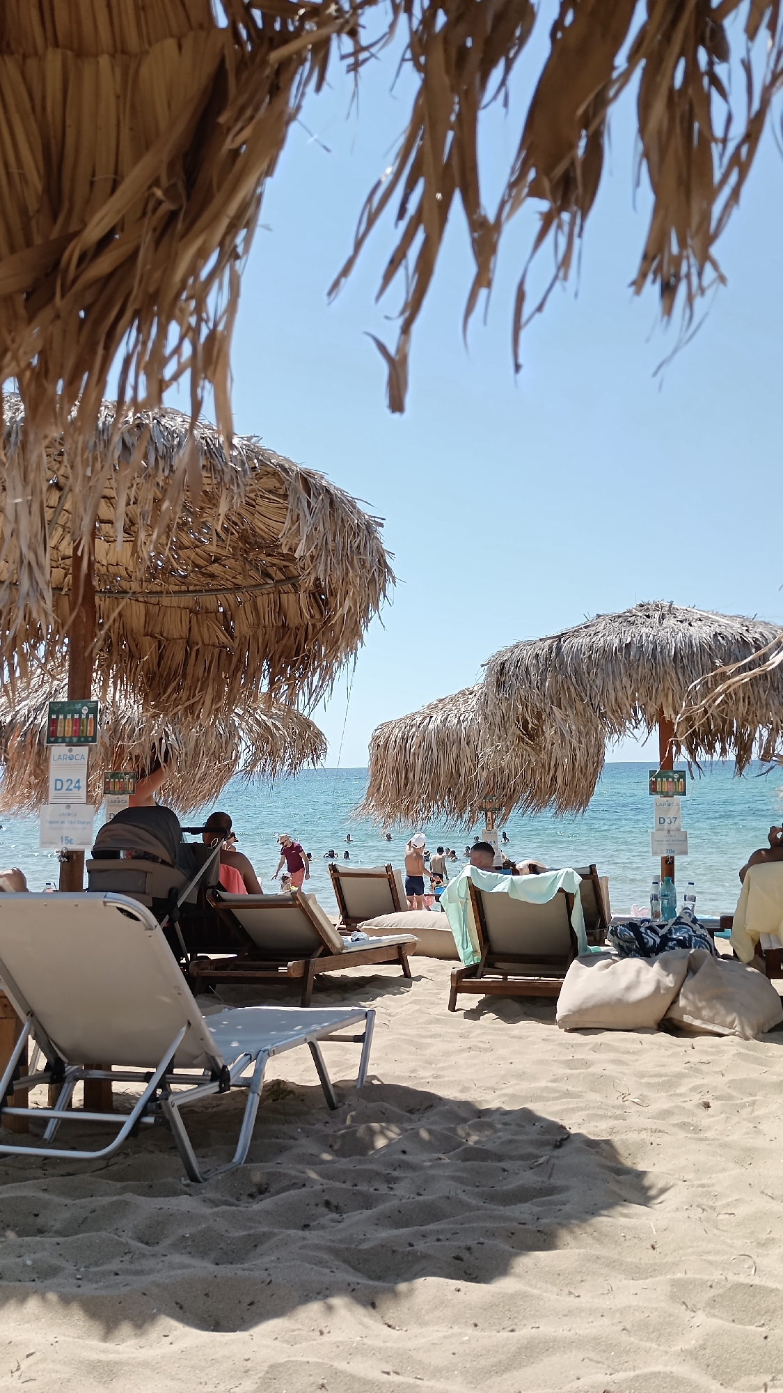 Quiet beach morning in Nea Peramos, chairs ready for the day