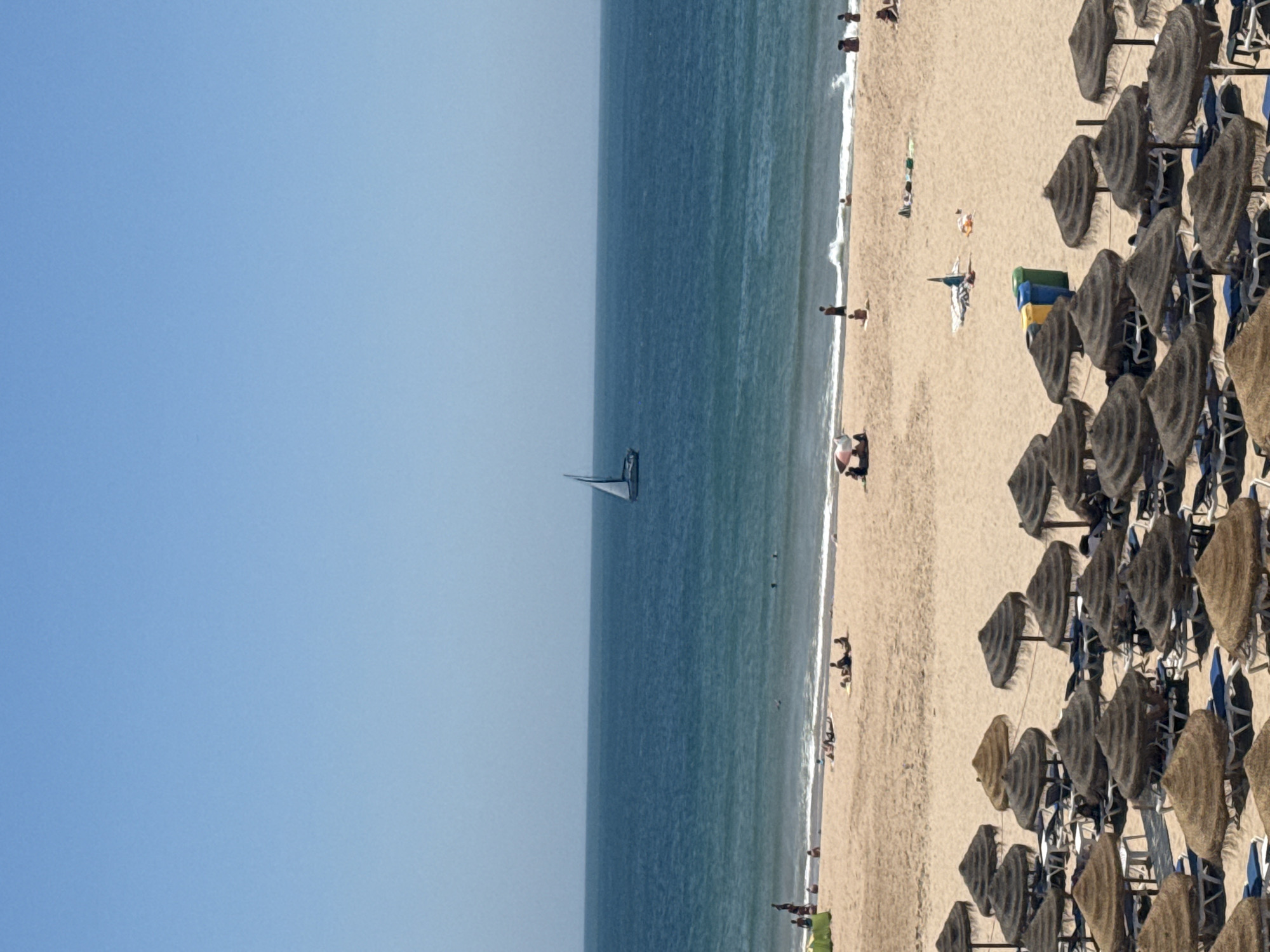 Sunny midday at a packed Cascais beach, Atlantic coast