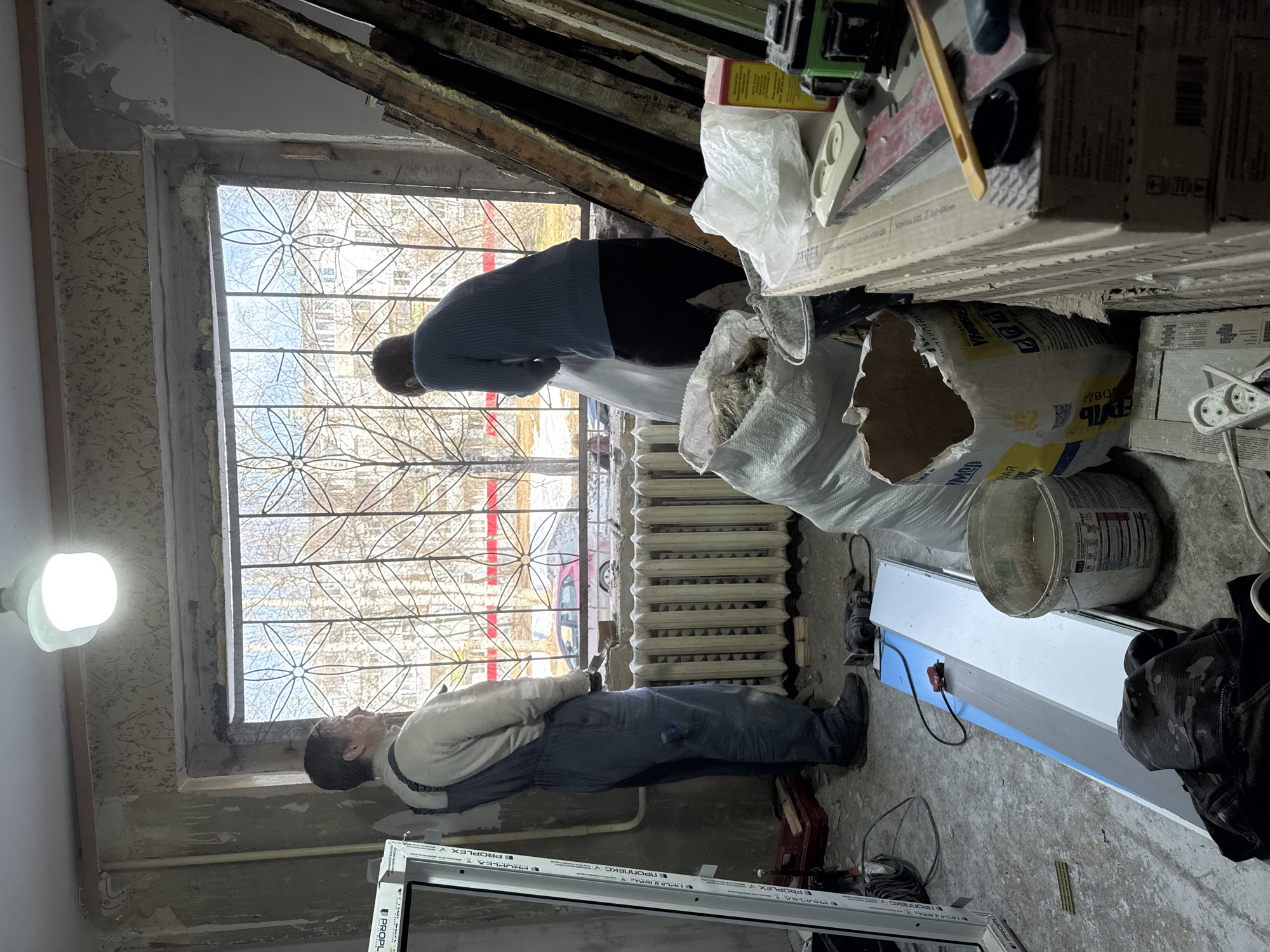 Window installers work on apartment renovation in Chaikovsky, Russia