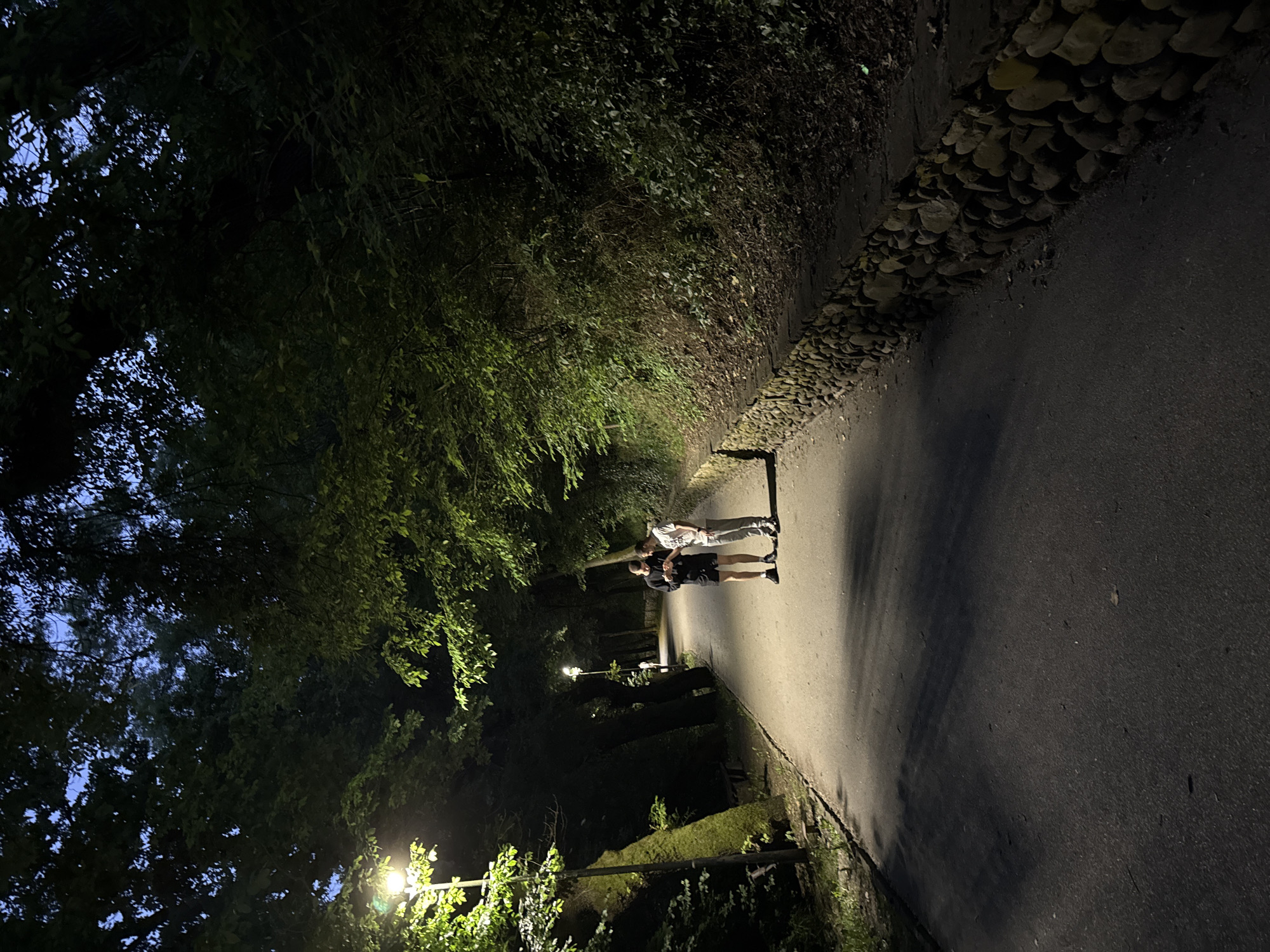 Two people stand on illuminated street in Lovech, Bulgaria