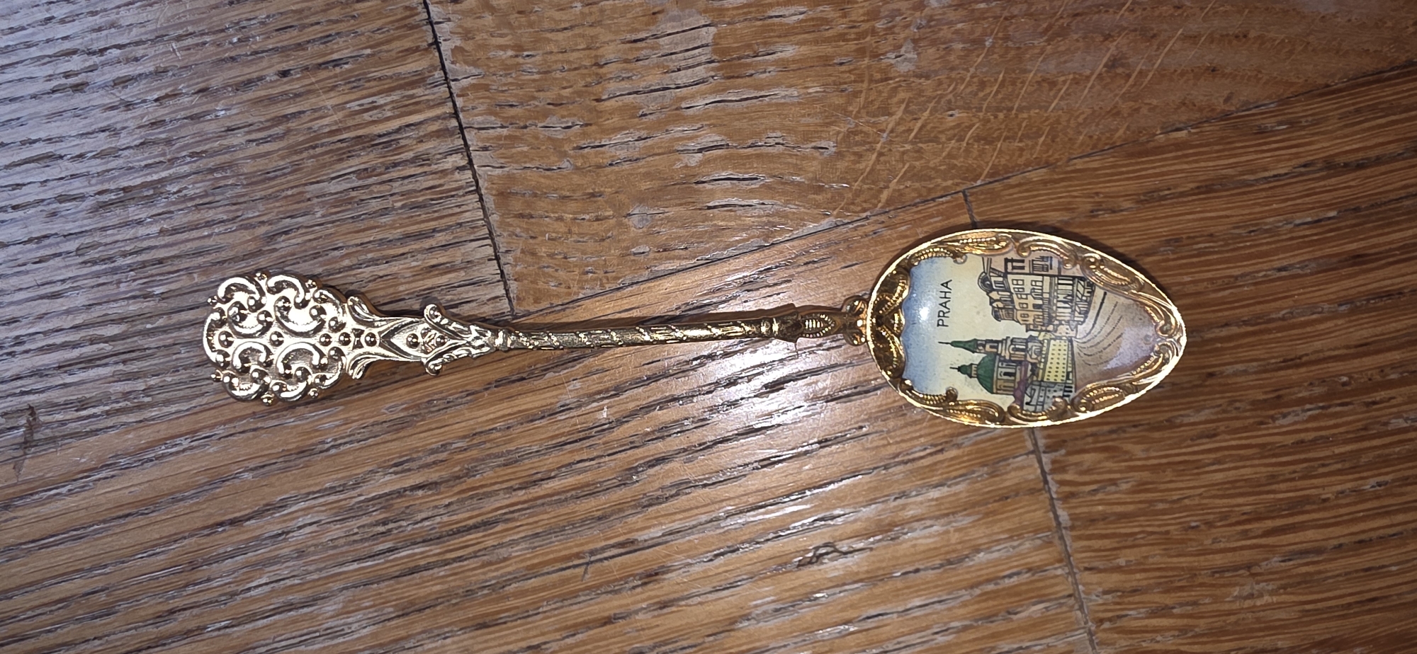 Antique souvenir spoons and coins laid out in Marum