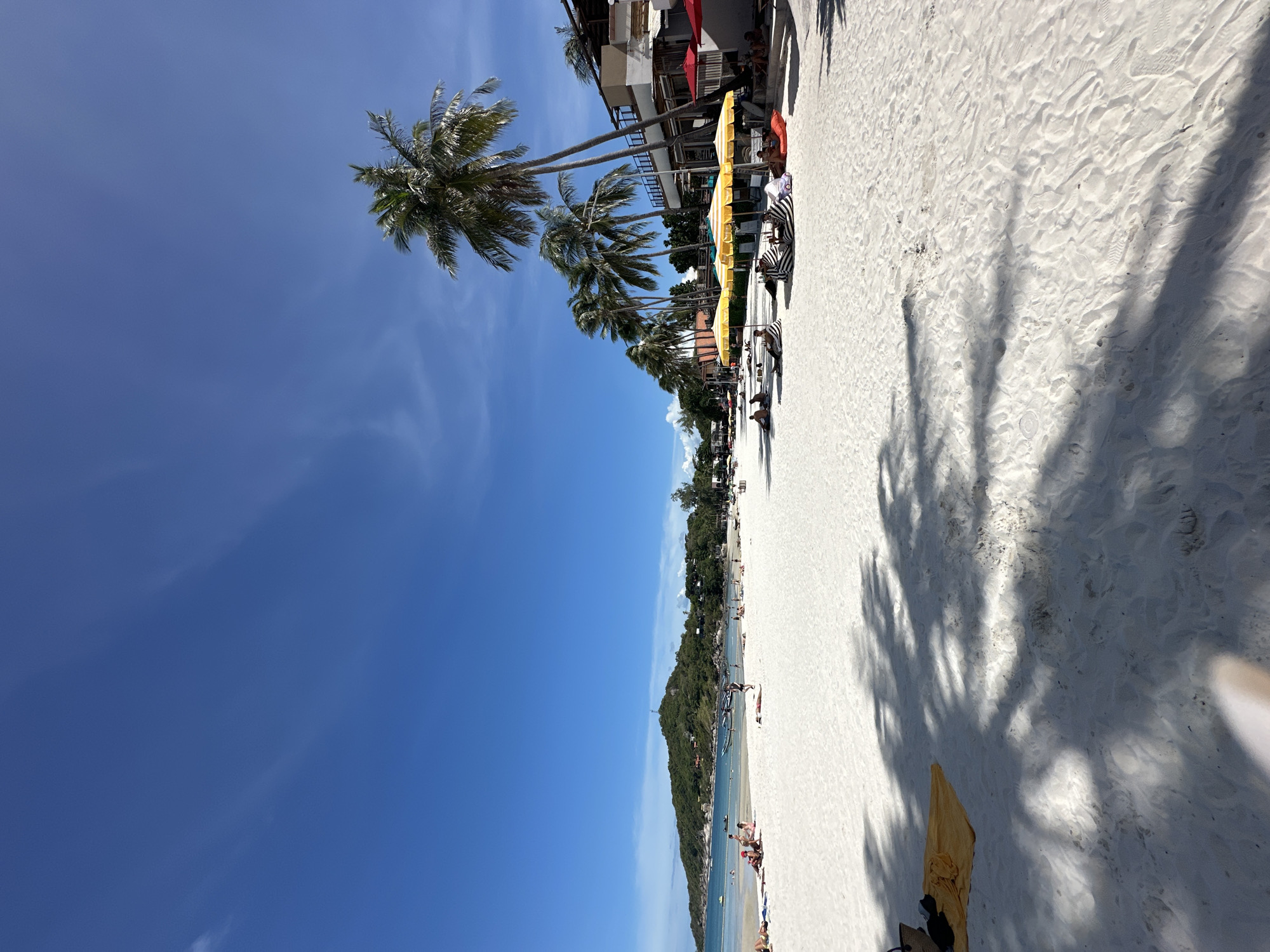 Sunny beach morning with a flip-flop vodka bottle sculpture nearby