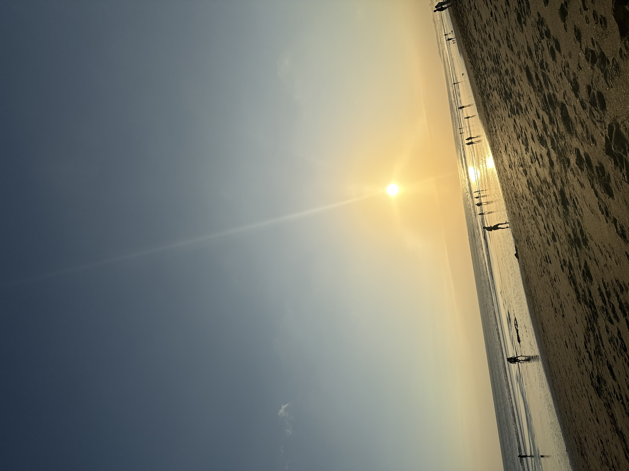 Bali's North Kuta beach at golden hour, live music nearby