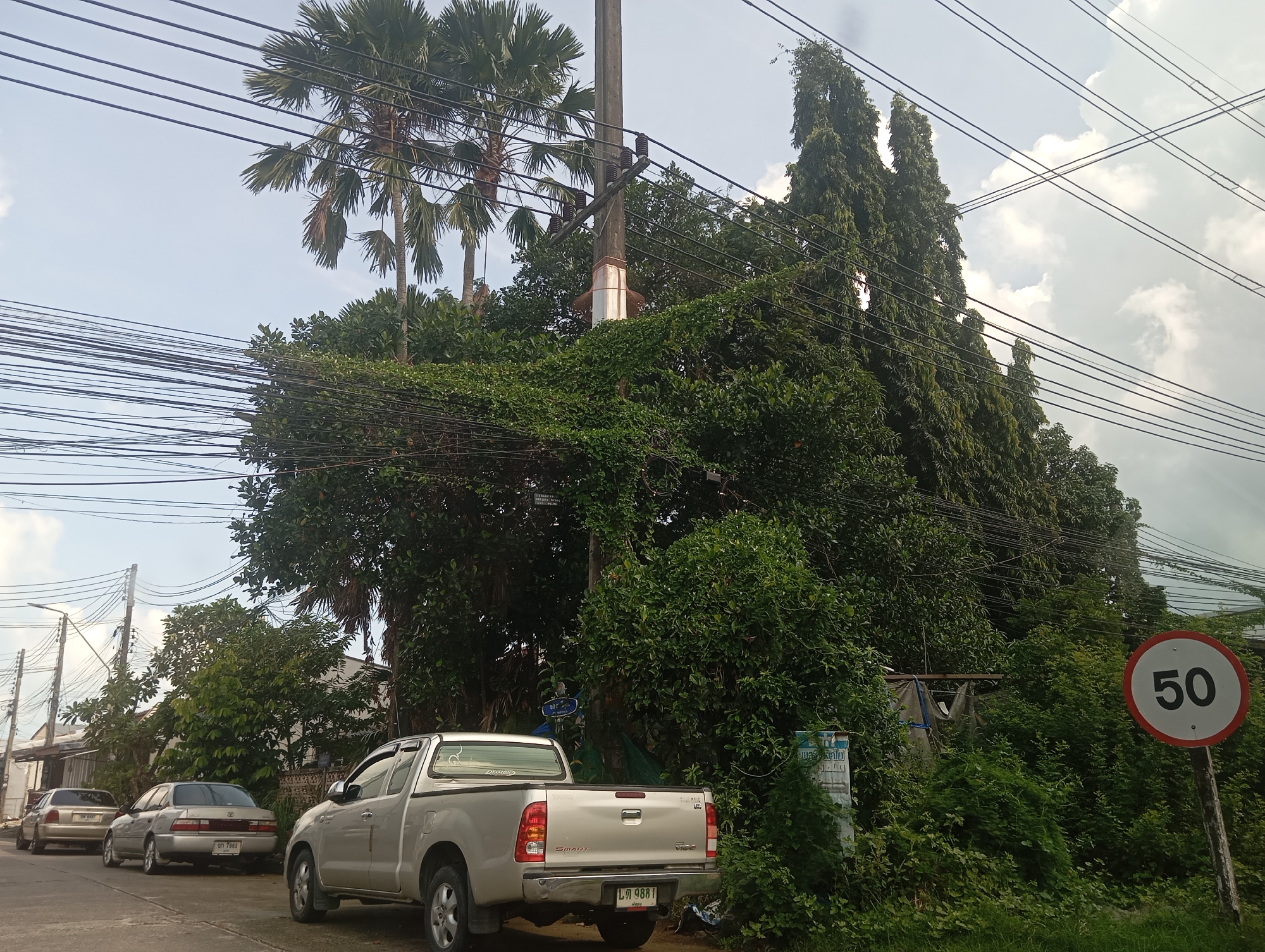 Morning street scene in Wichit, construction truck and local buildings
