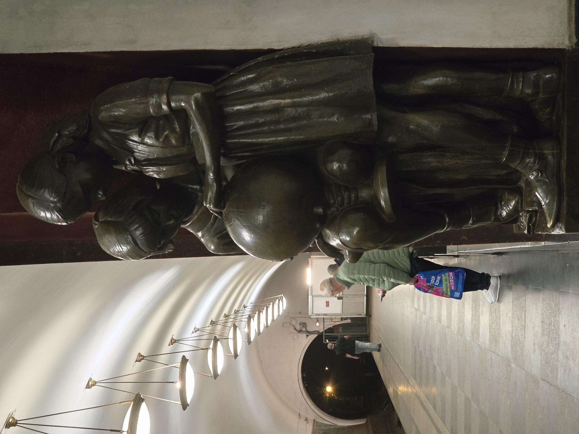 Bronze sculptures documented at Stockholm Metro Station during morning commute