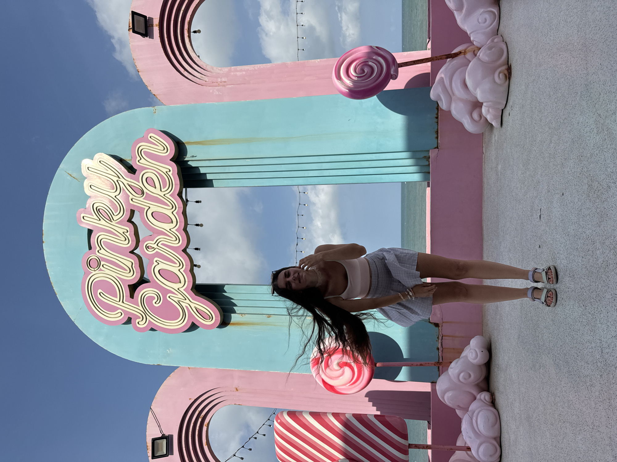 Woman visits colorful Pinky Garden cafe in Vietnam morning
