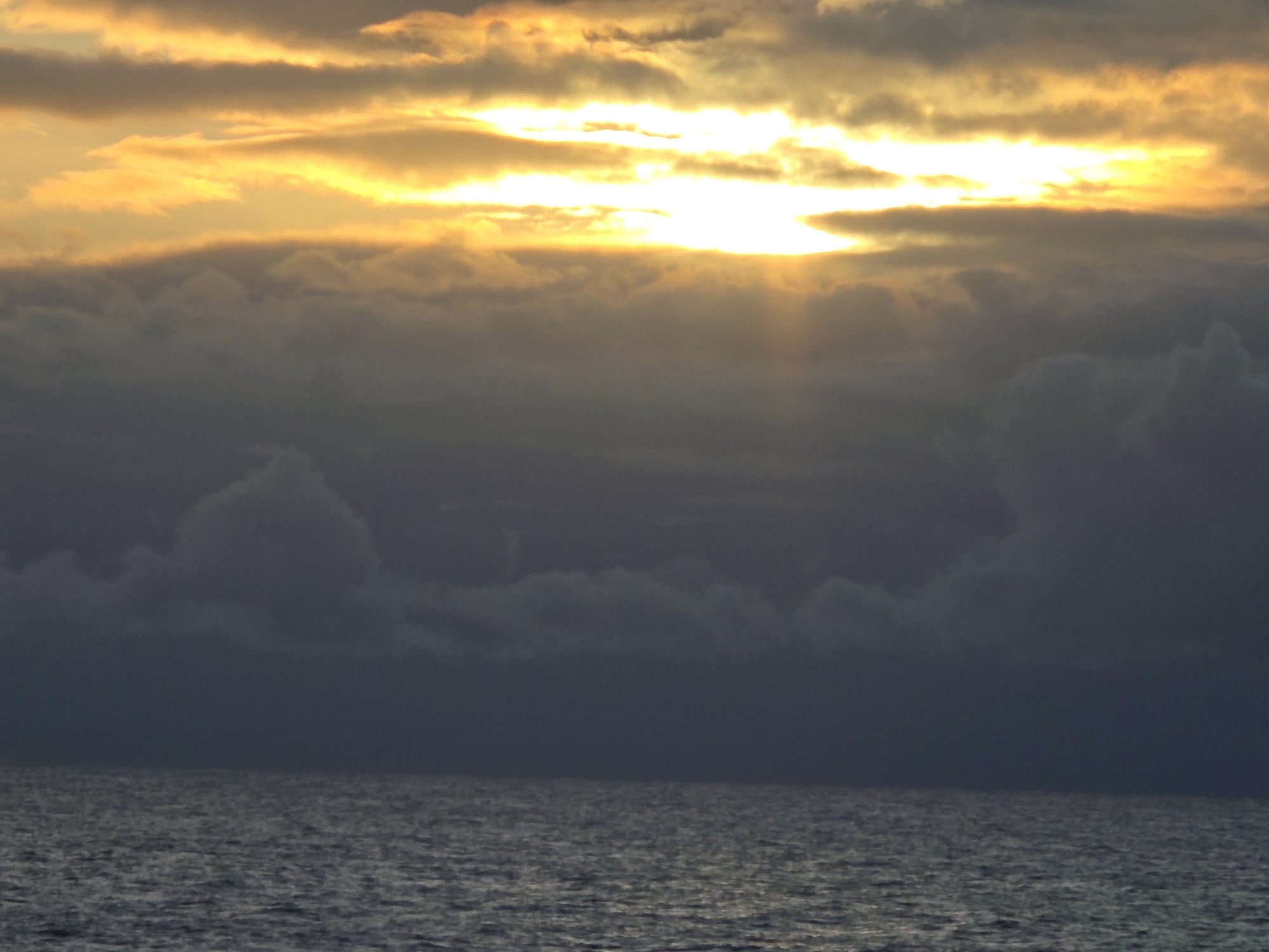 Twilight seascape captured with changing clouds and rippling waters